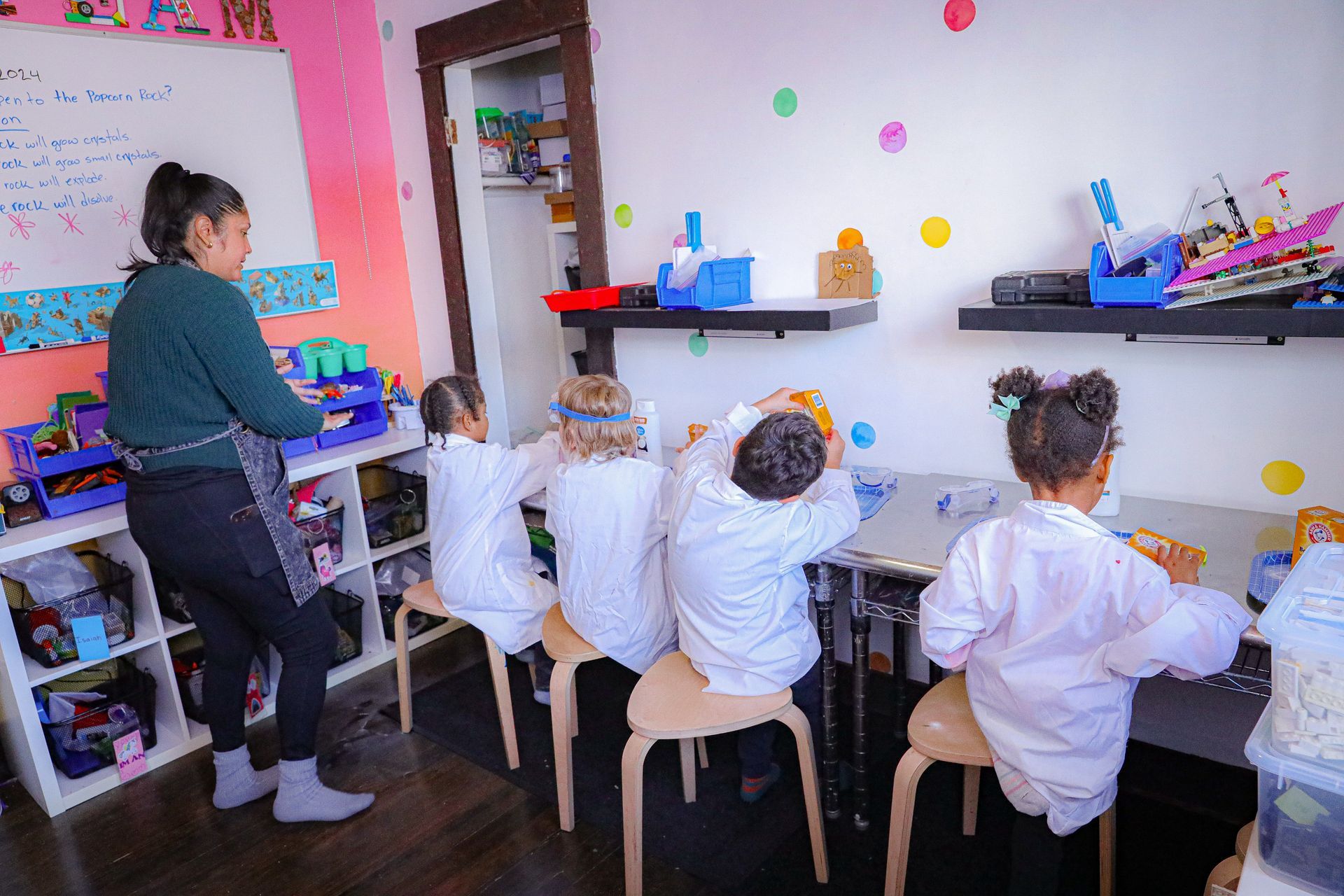 A boy and a girl are working on a robot together.