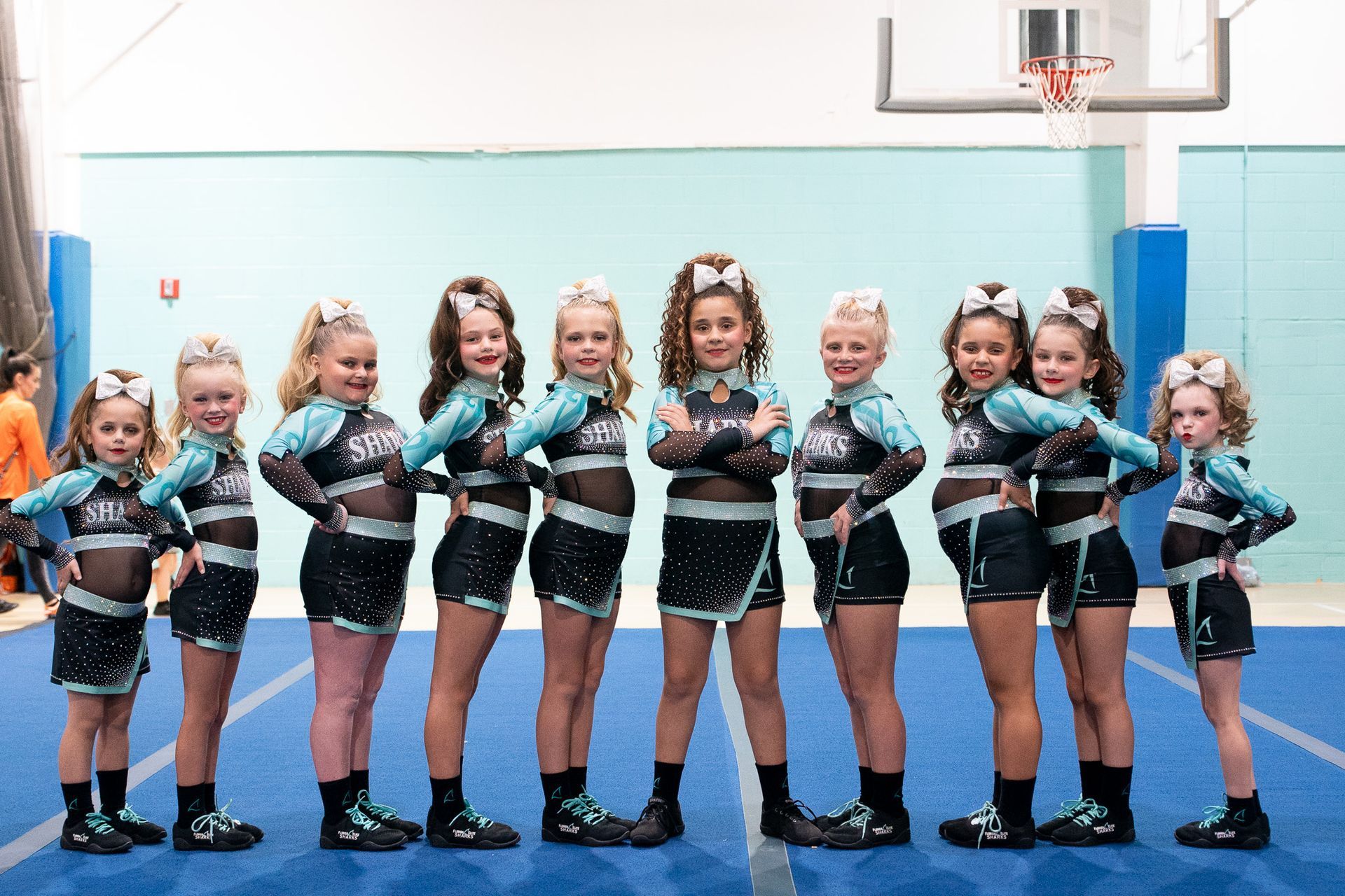 A group of cheerleaders from the florida elite sharks are posing for a picture.