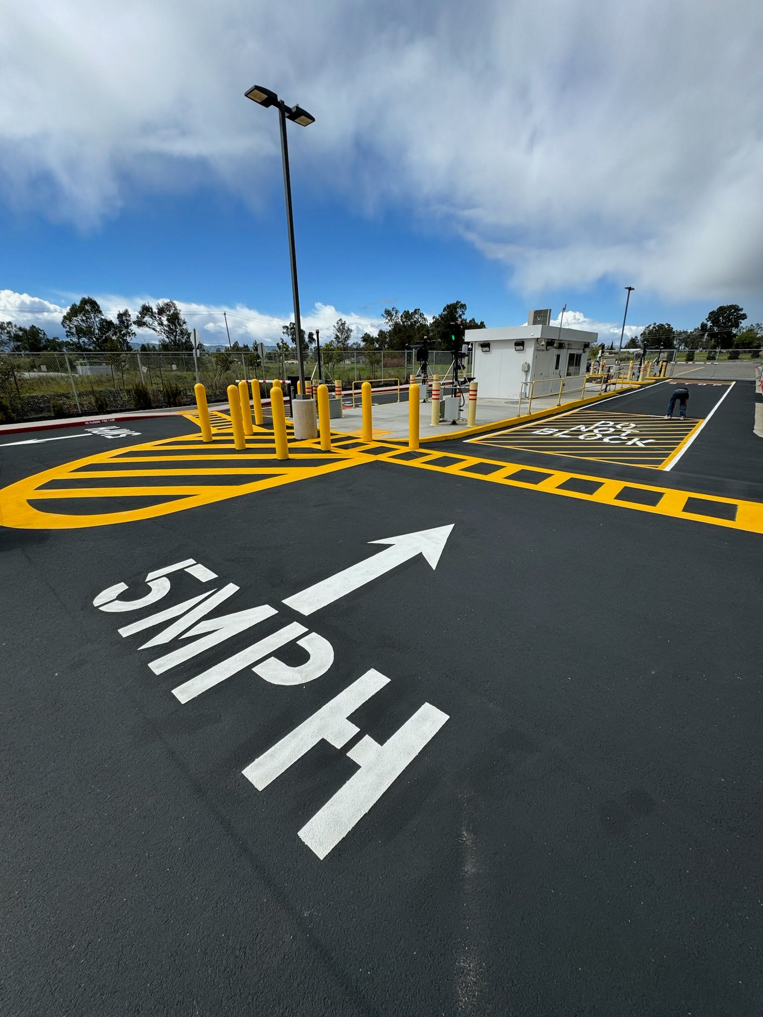 A parking lot with an arrow pointing to the right that says simply