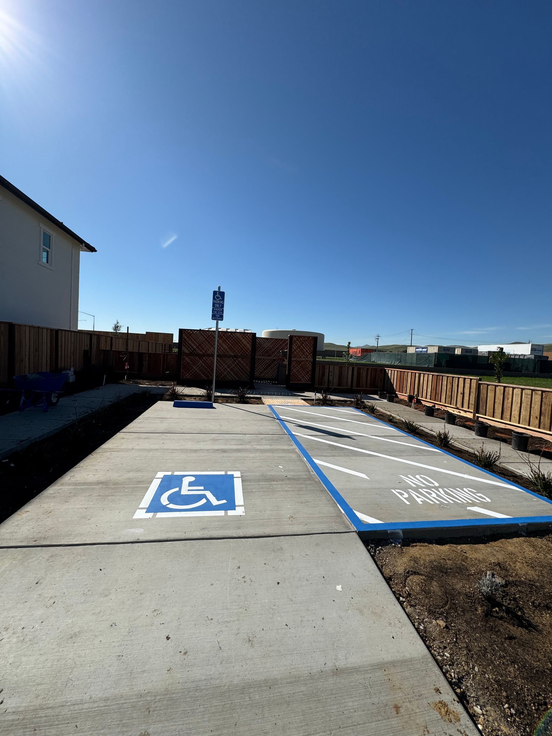 A handicapped parking spot is painted on the side of the road