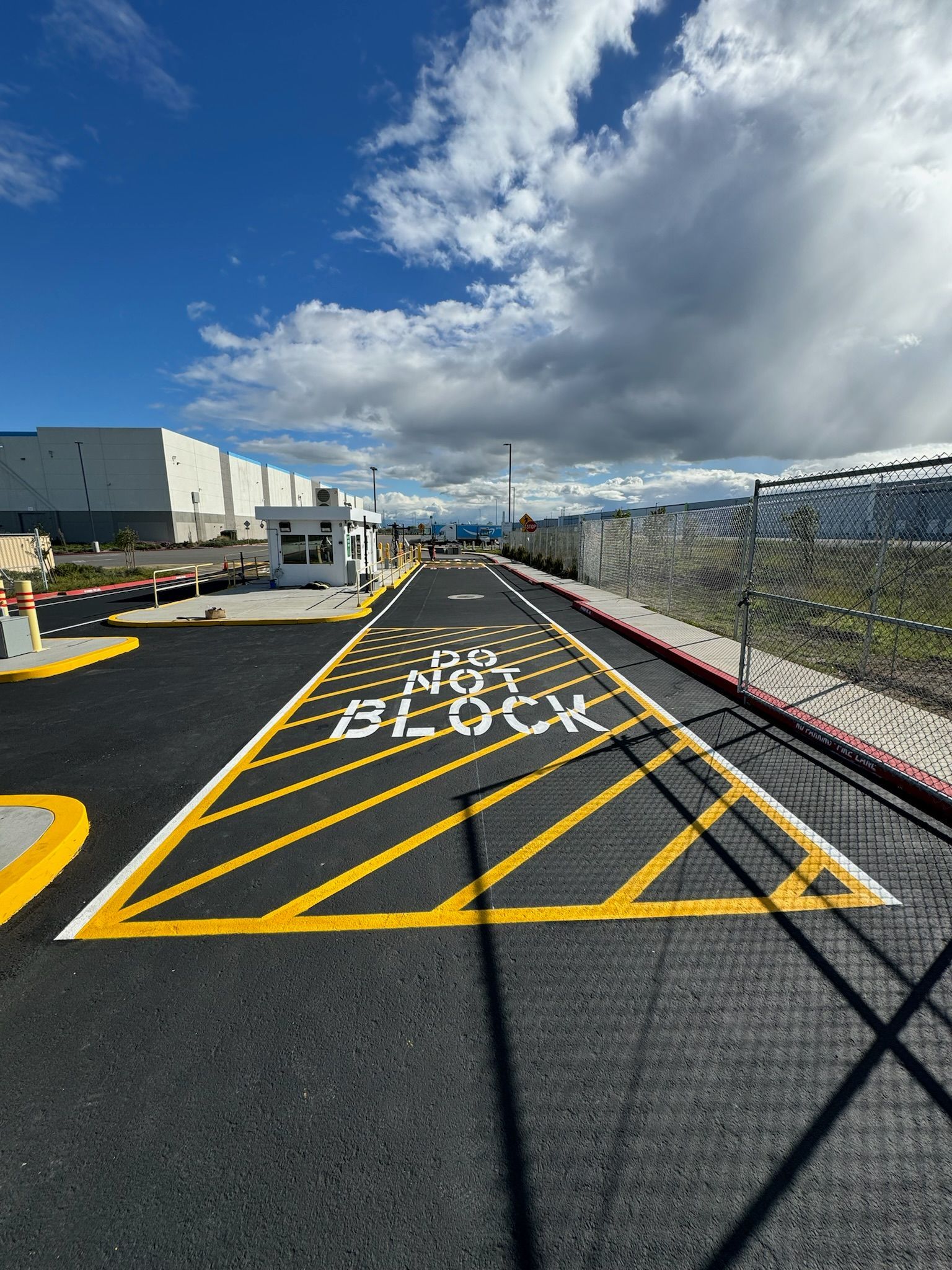 A road with yellow lines and the word block painted on it.