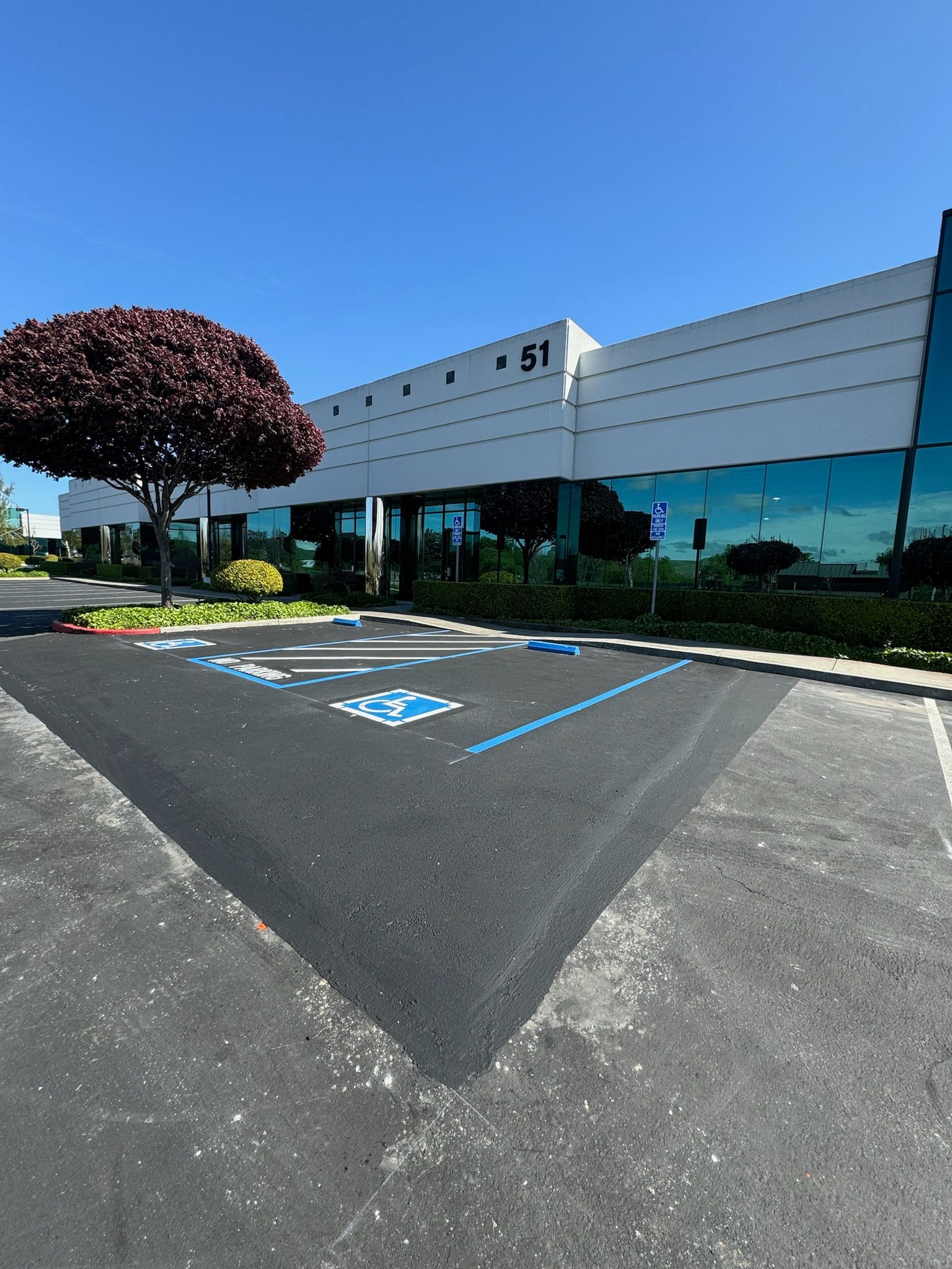 A large building with a handicapped parking spot in front of it