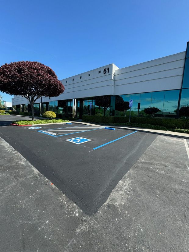 A large building with a handicapped parking spot in front of it