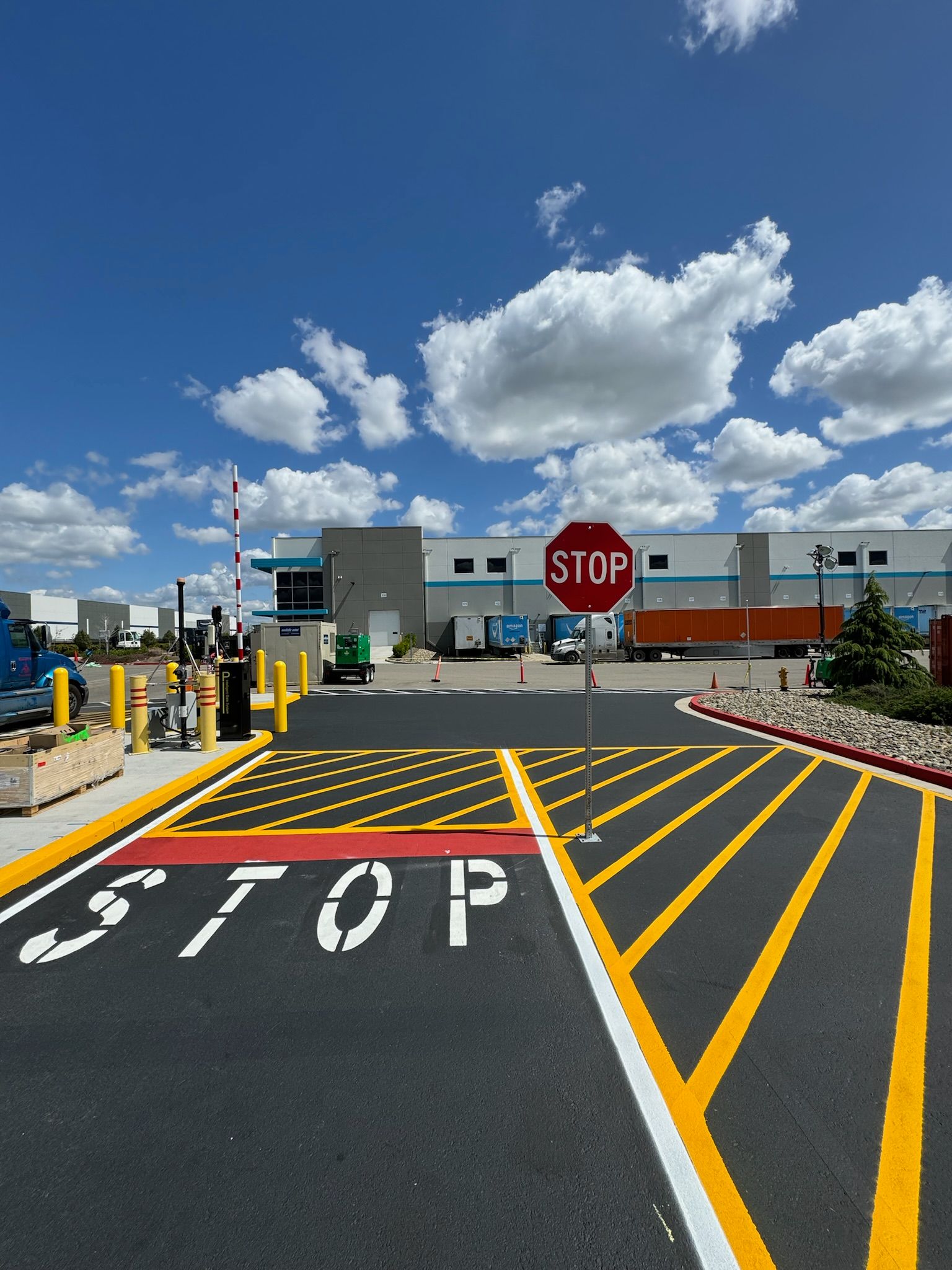 A stop sign is in the middle of a parking lot
