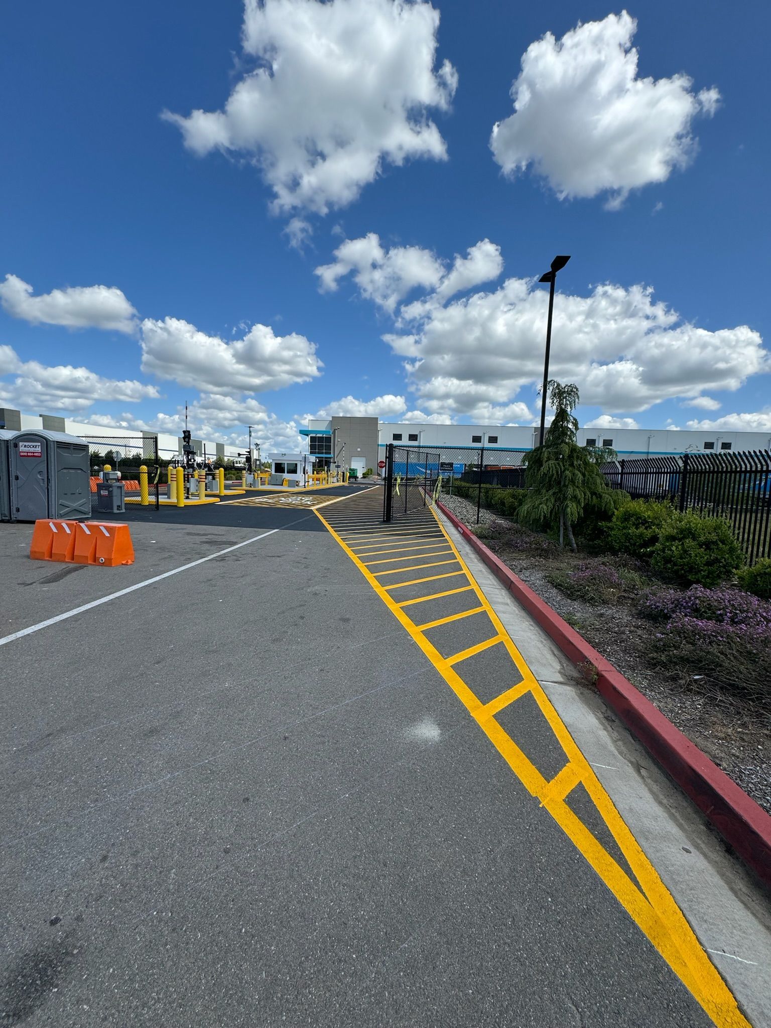 A parking lot with a yellow line on the side of the road.