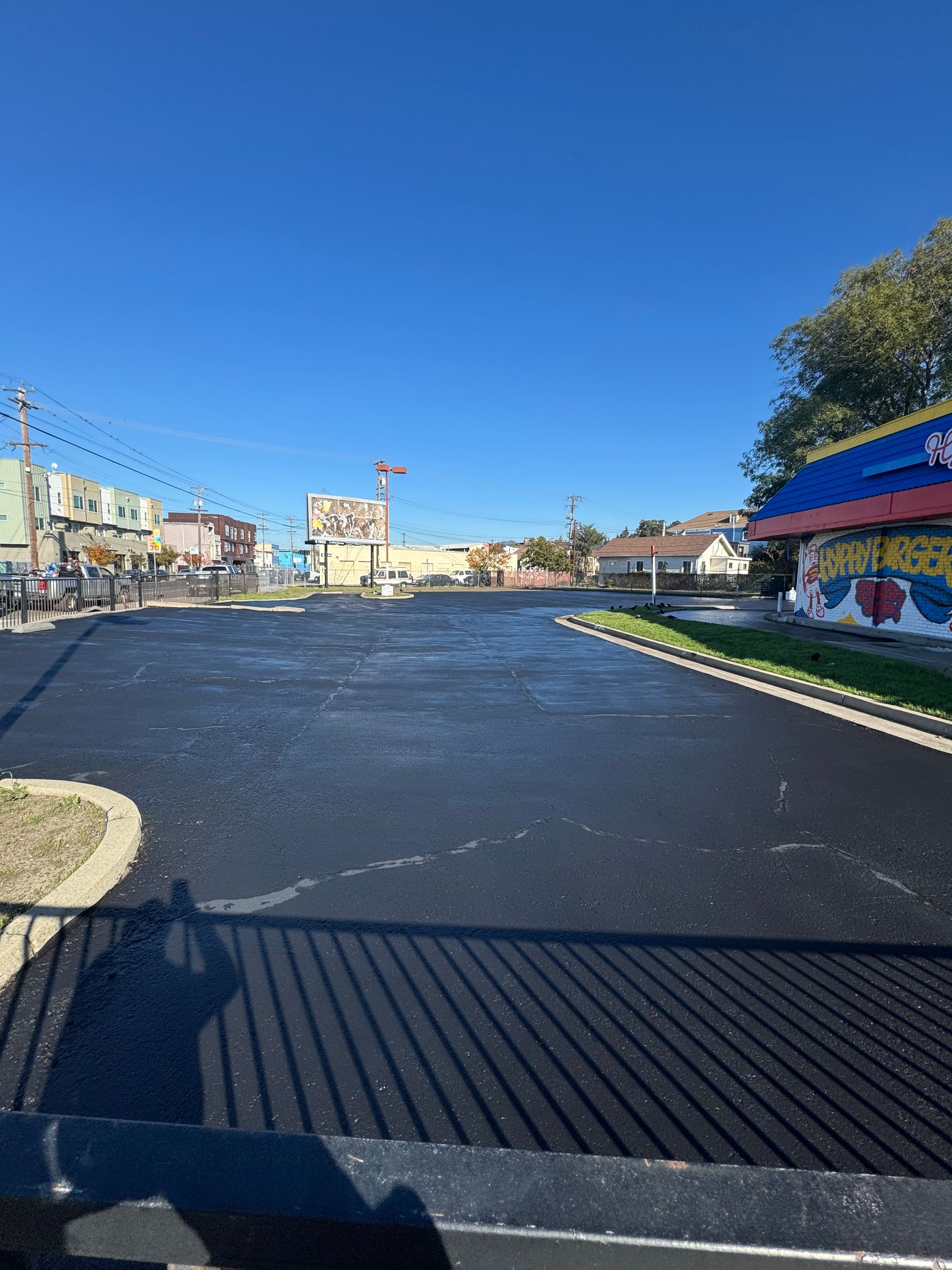 An empty parking lot with a building in the background.