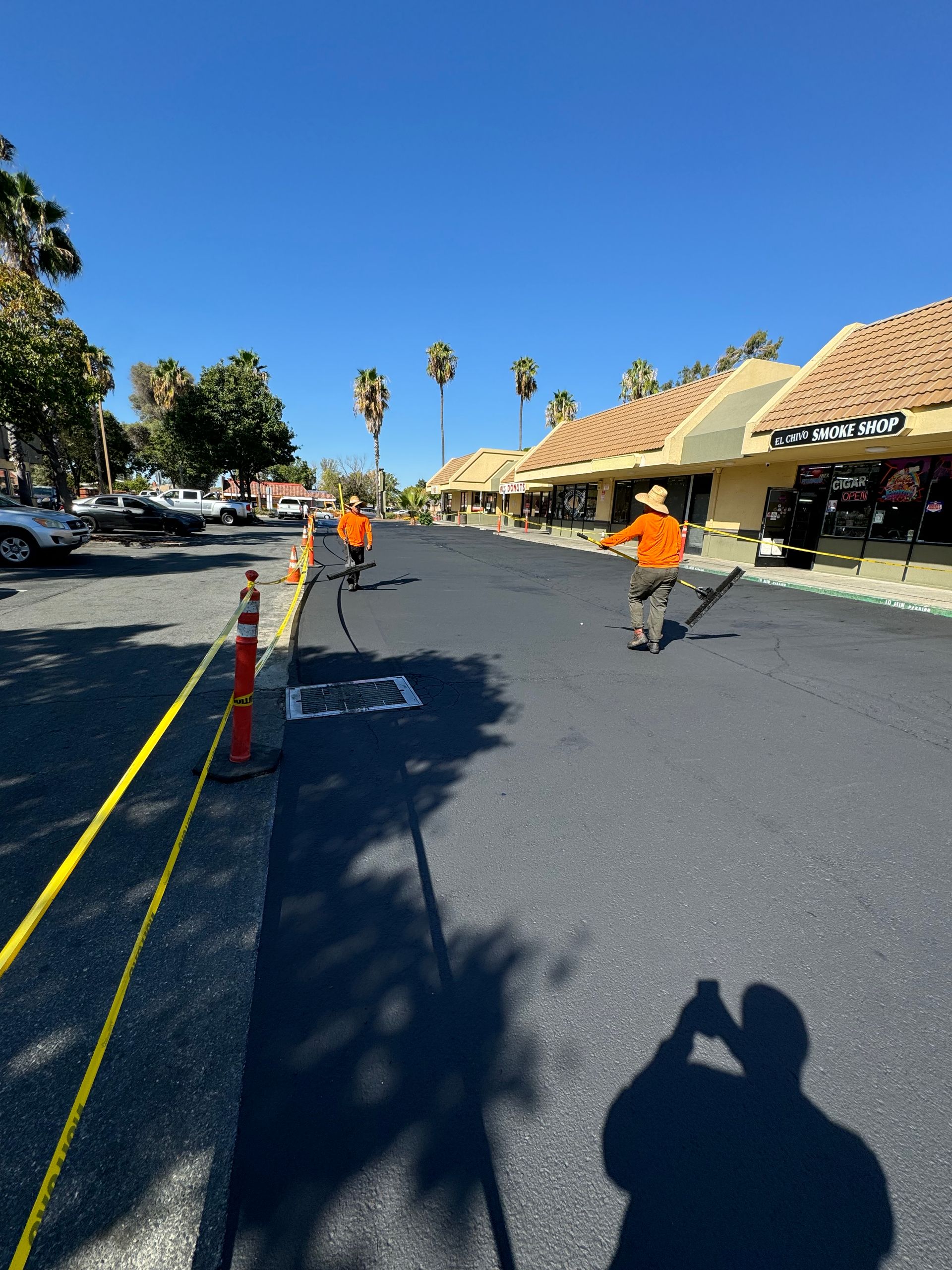 A shadow of a person taking a picture of a road