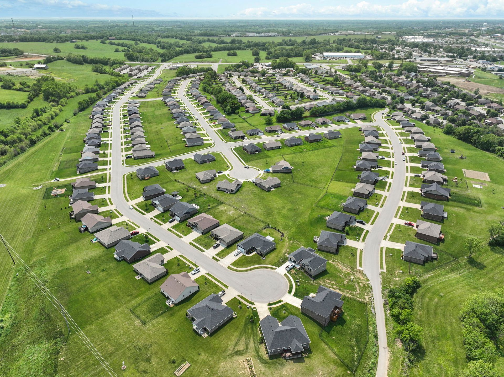 An aerial view of a residential area with lots of houses and trees.