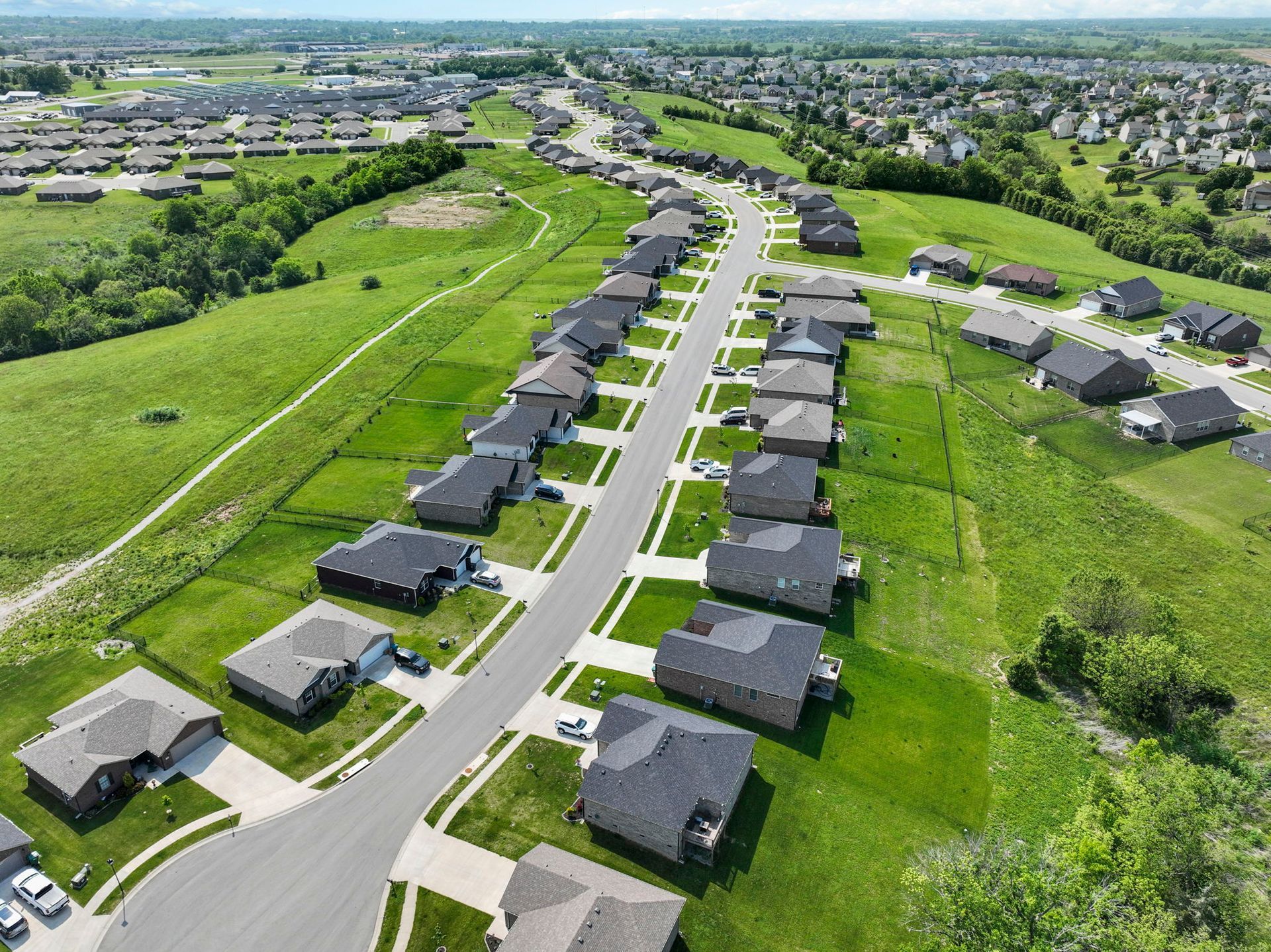 An aerial view of a residential neighborhood with lots of houses and trees.
