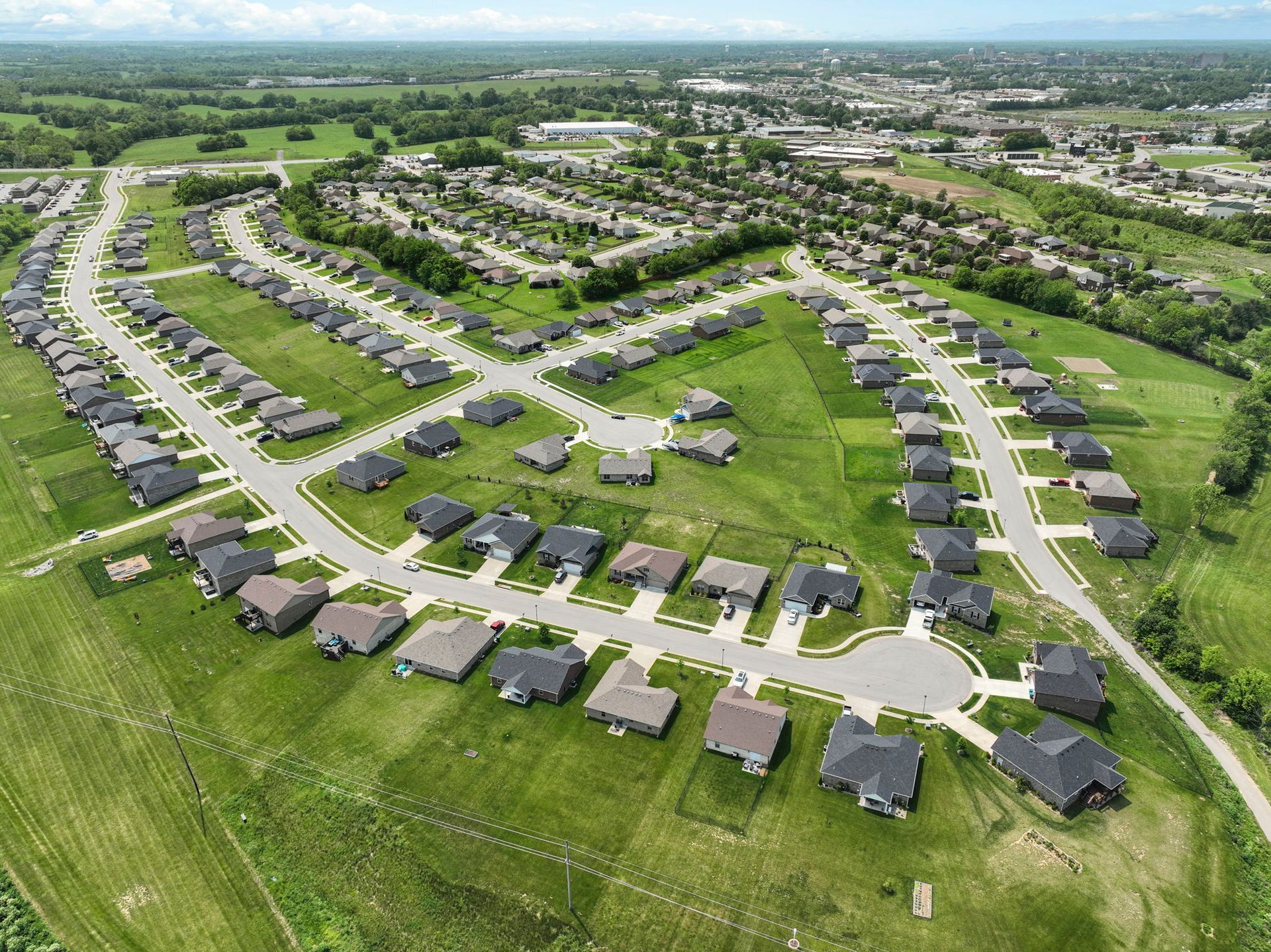 An aerial view of a residential area with lots of houses and trees.