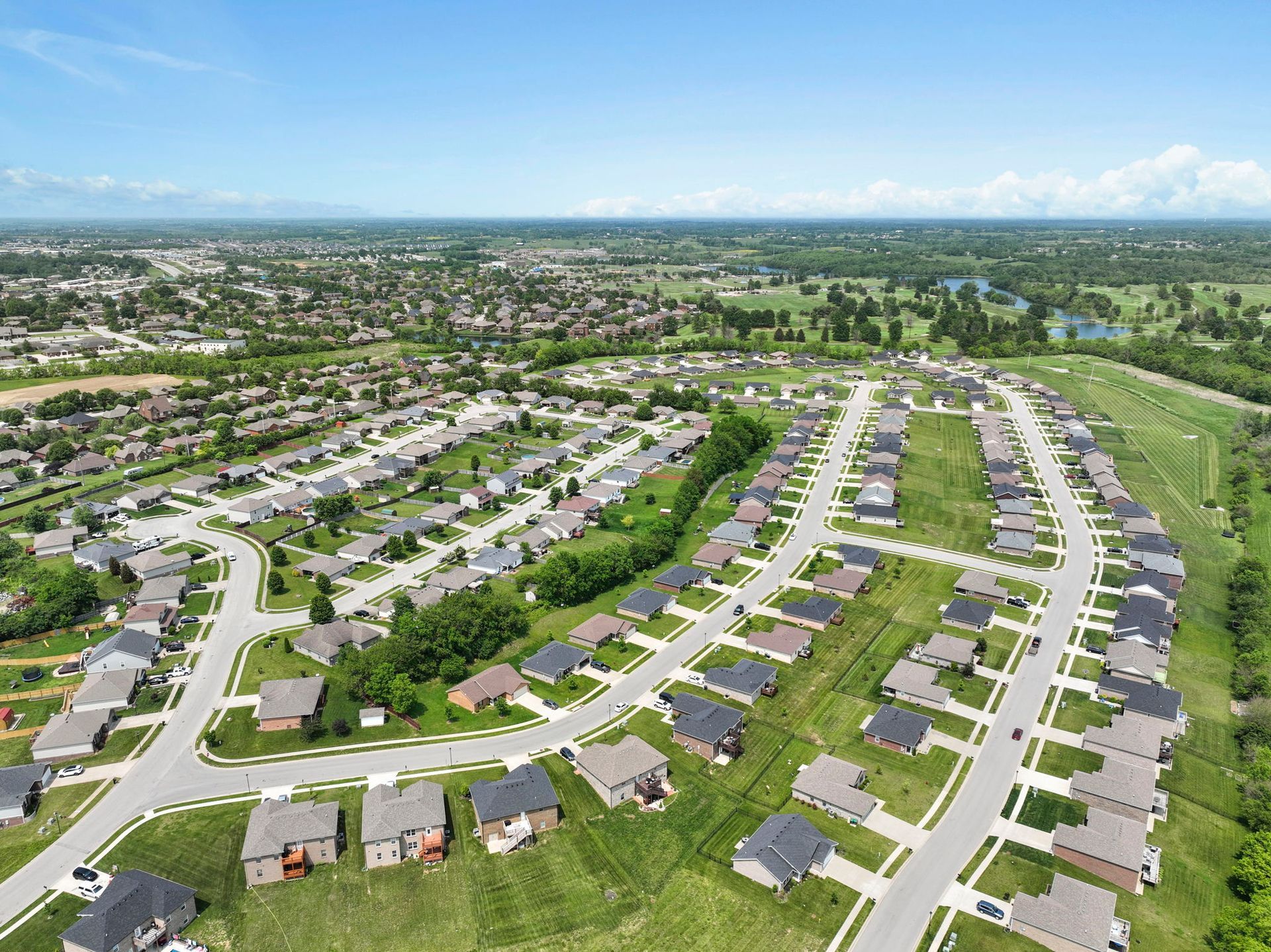 An aerial view of a residential neighborhood with lots of houses and trees.