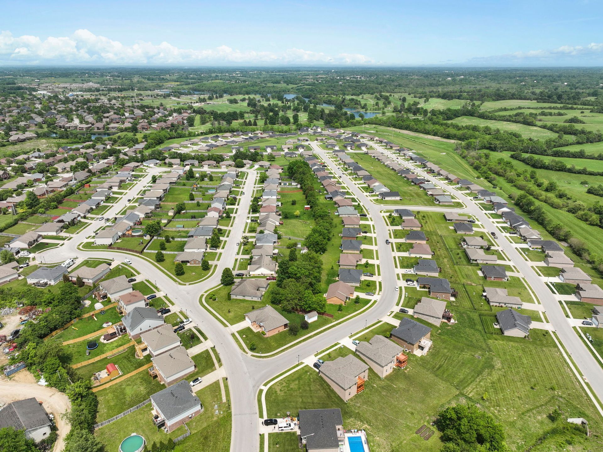 An aerial view of a residential neighborhood with lots of houses and trees.