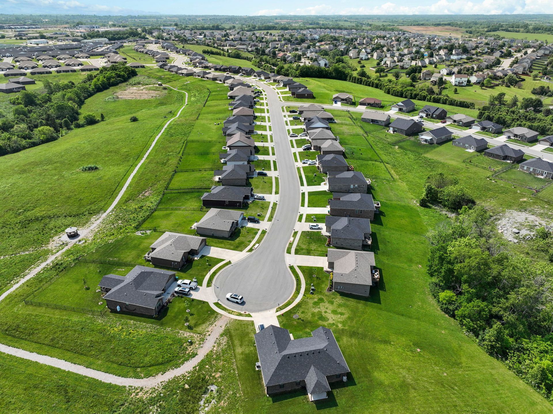 An aerial view of a residential area with lots of houses and grass.