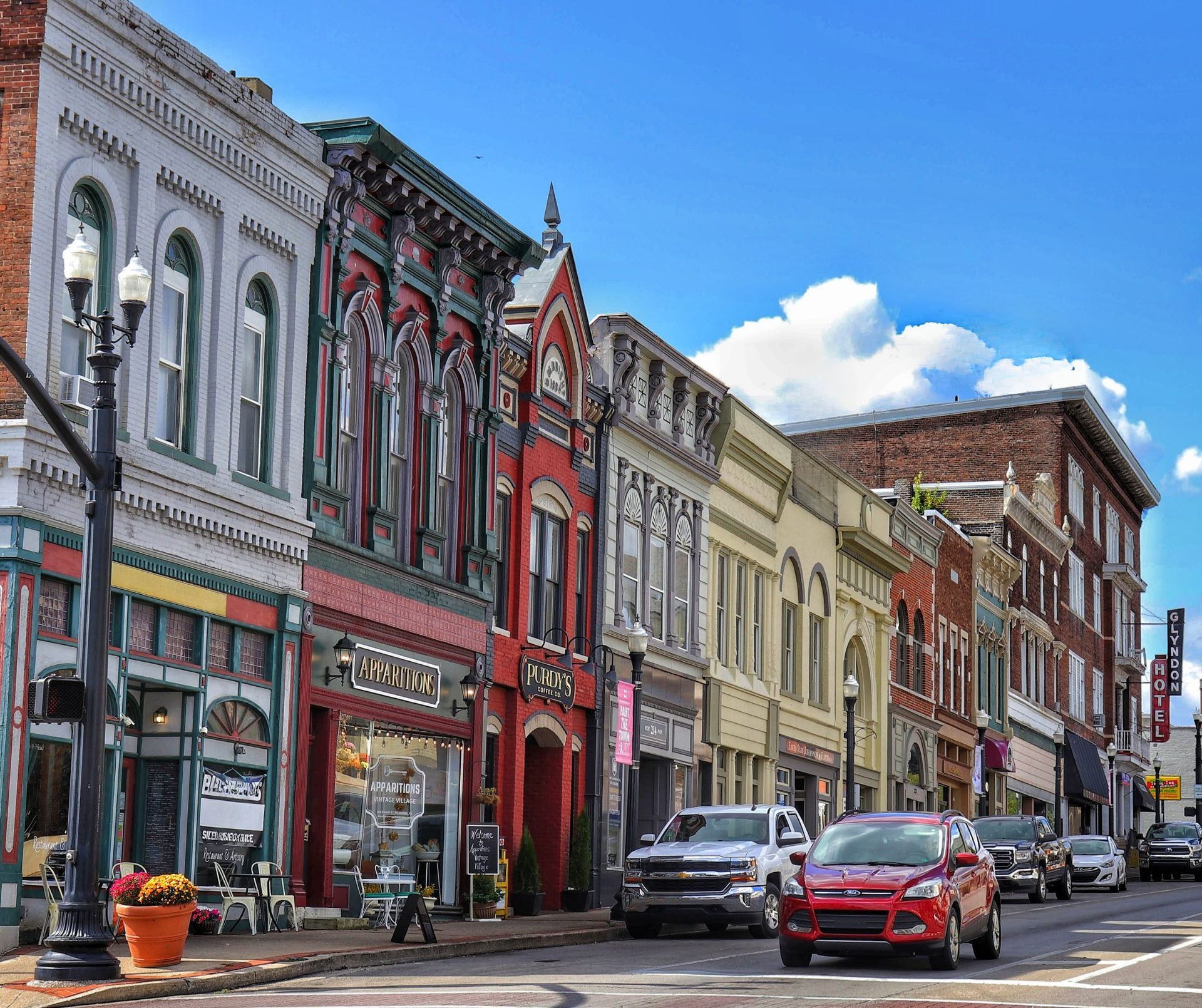 A row of buildings are lined up on a city street.