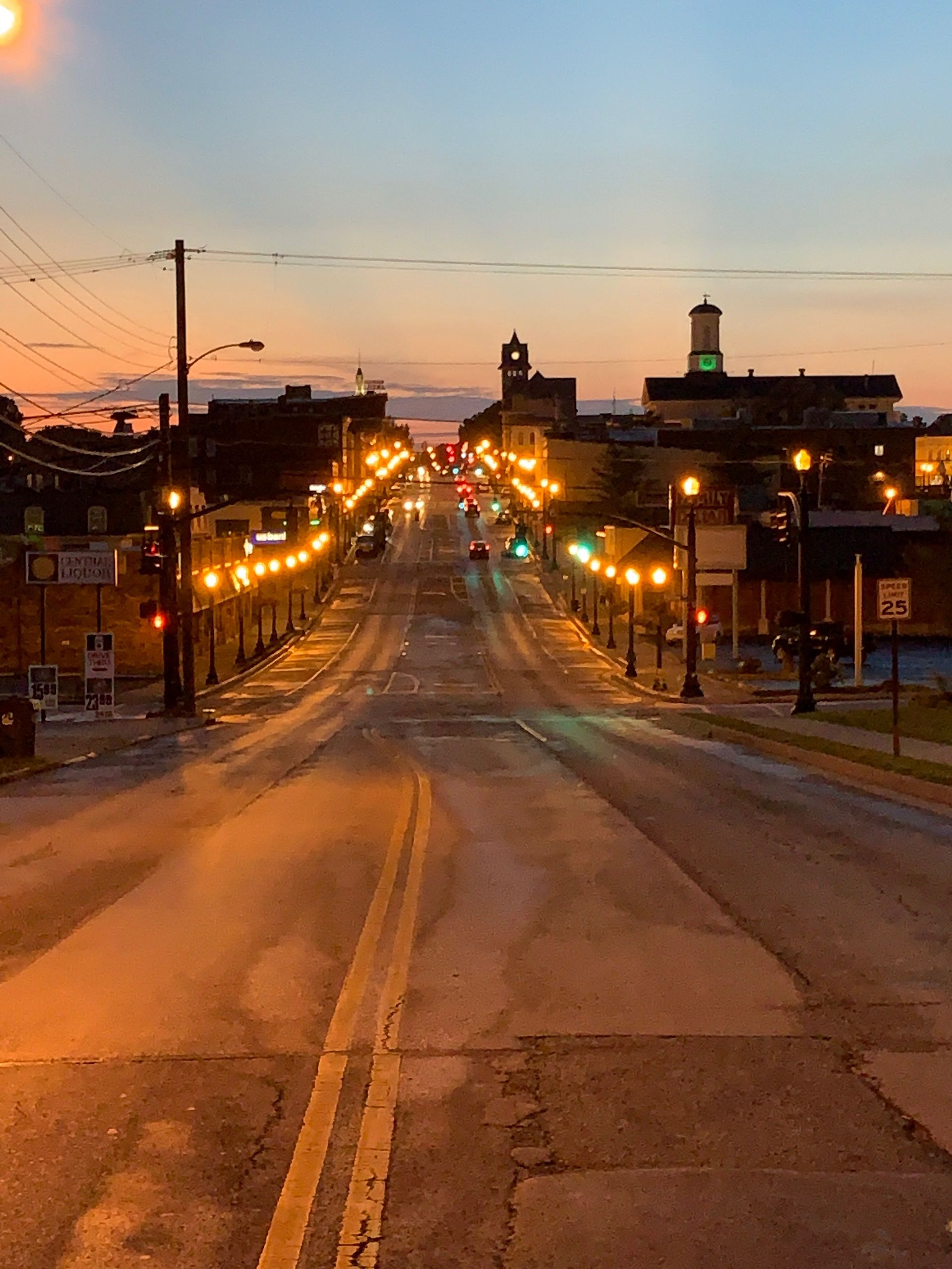 An empty street with a sunset in the background