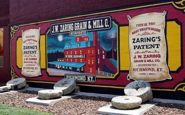 A mural on the side of a building that says j.w. zaring grain & mill co.