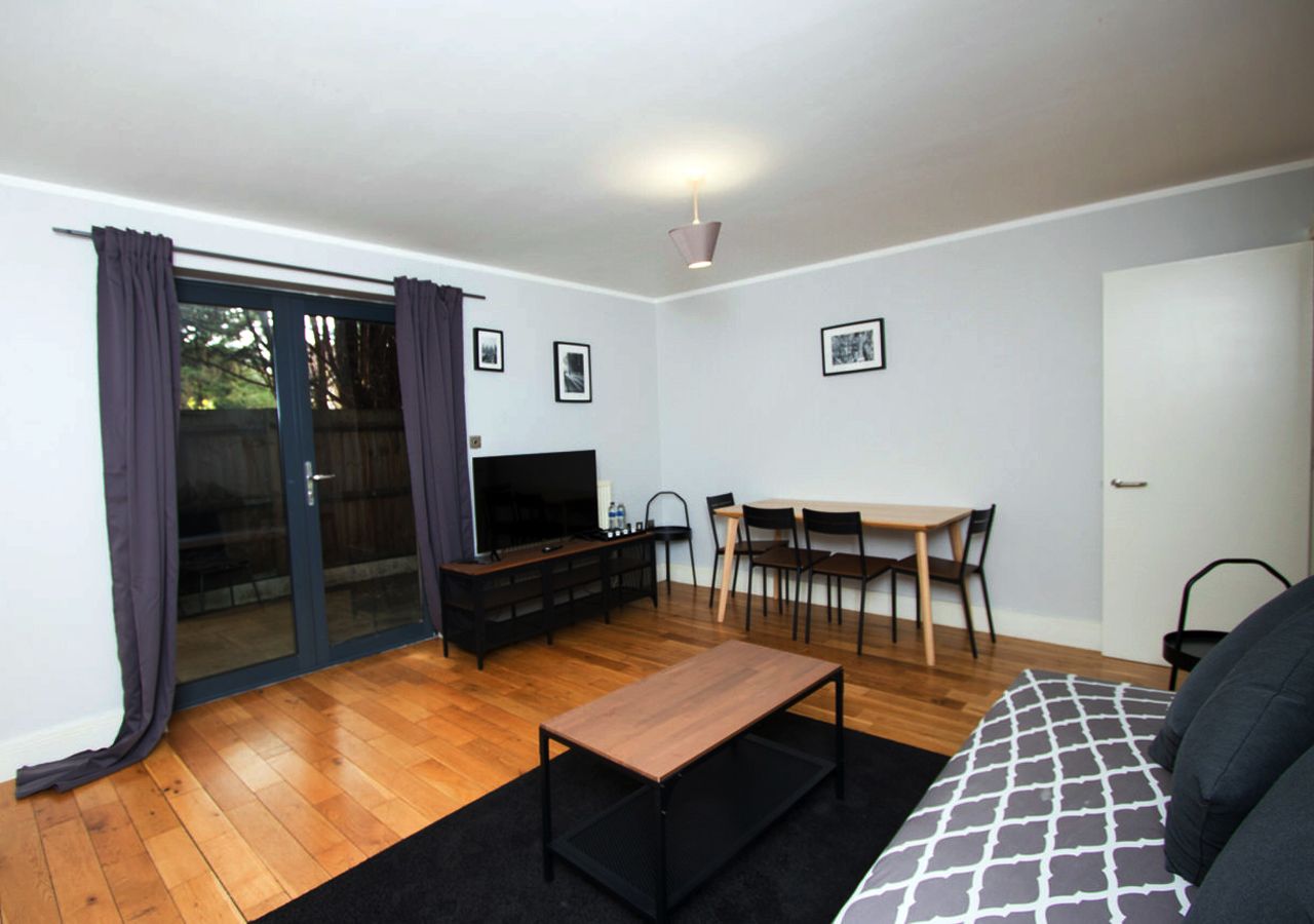 A living room with a couch a table and chairs