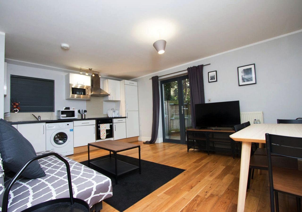 A living room with a couch a table and a television