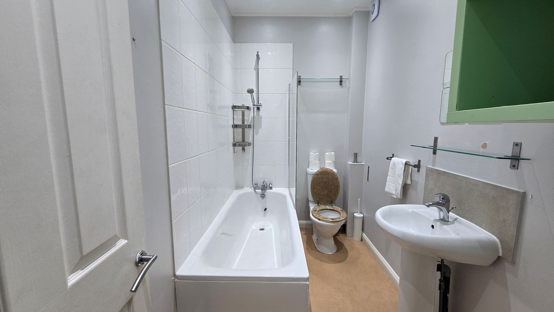 A bathroom with a sink , toilet , bathtub and shower.