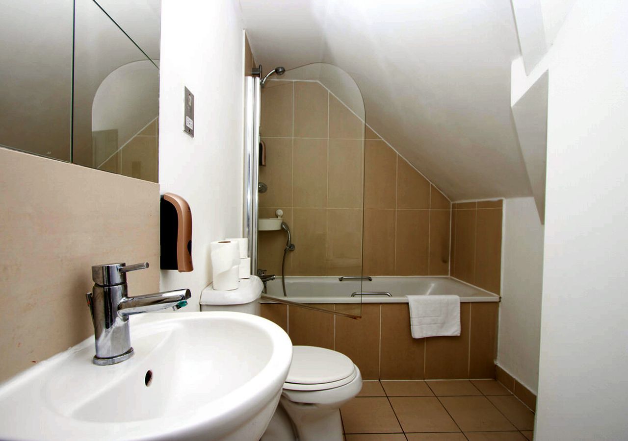 A bathroom with a sink toilet and bathtub