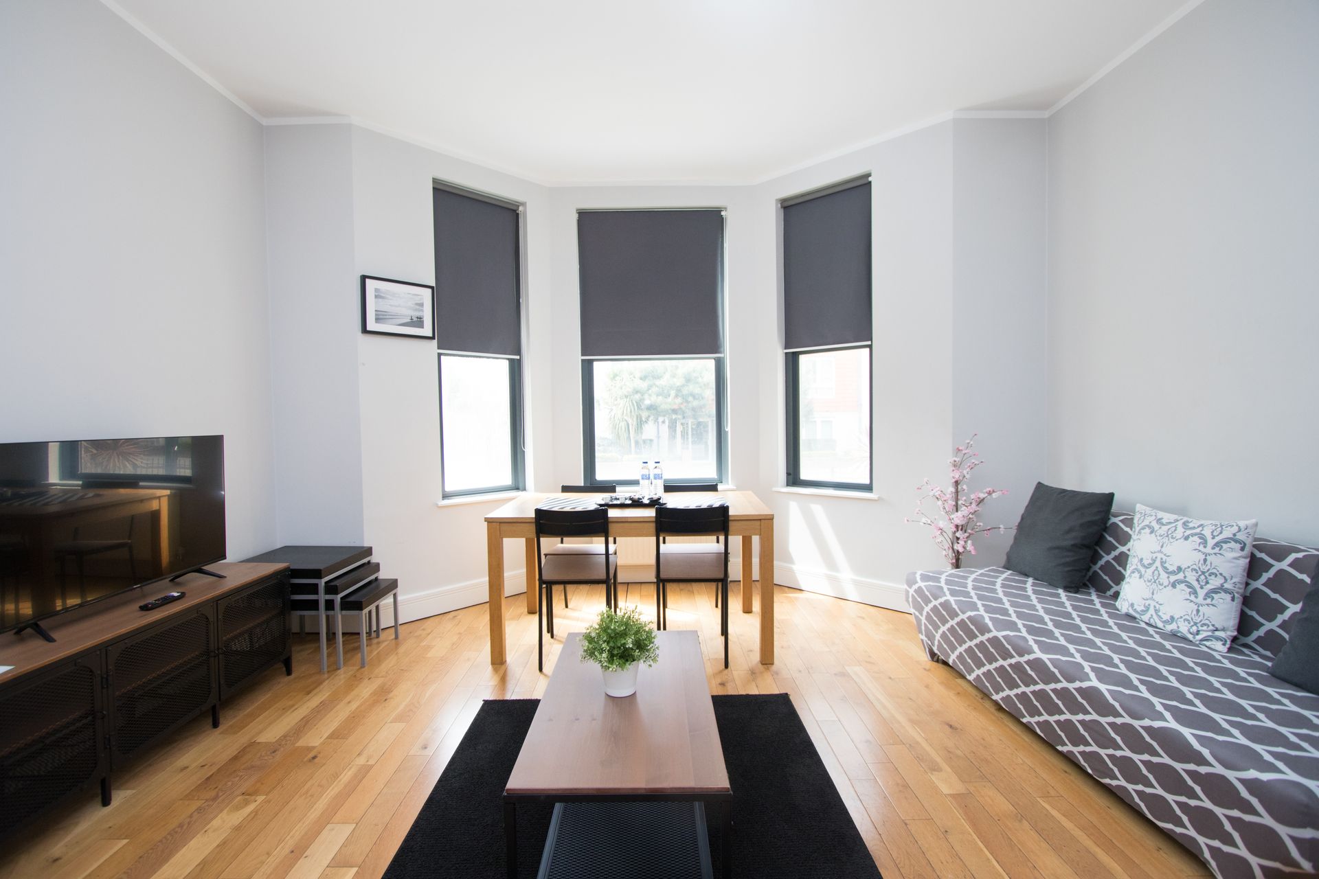 A living room with a couch a table and a television