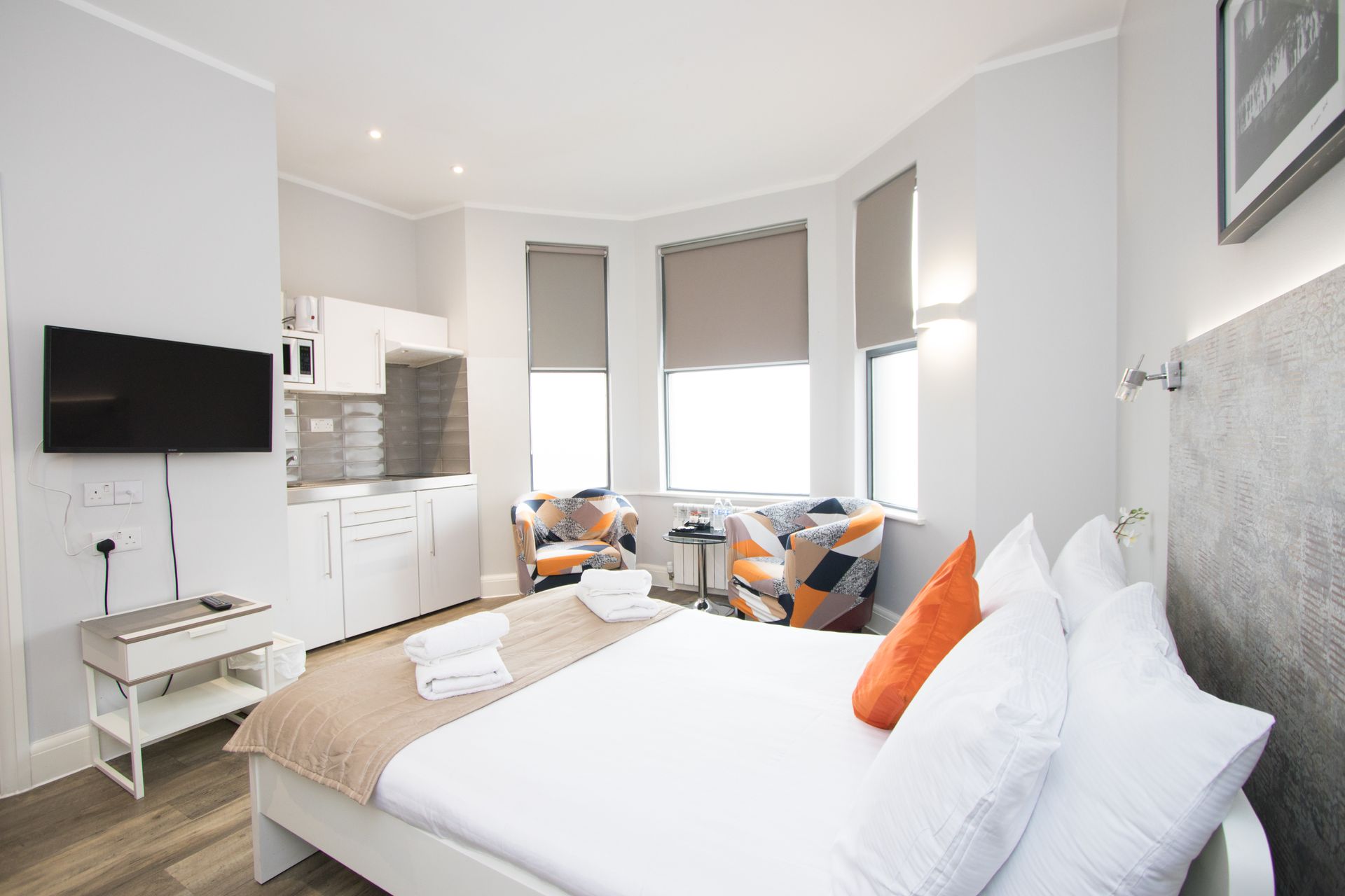 A bedroom with a large bed and a flat screen tv