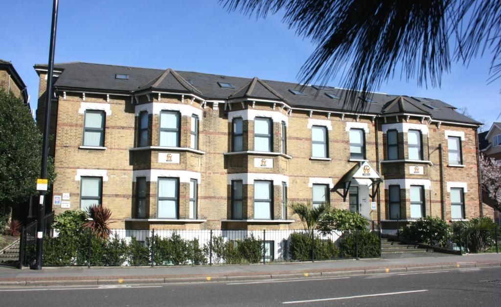 A large brick building with a palm tree in front of it