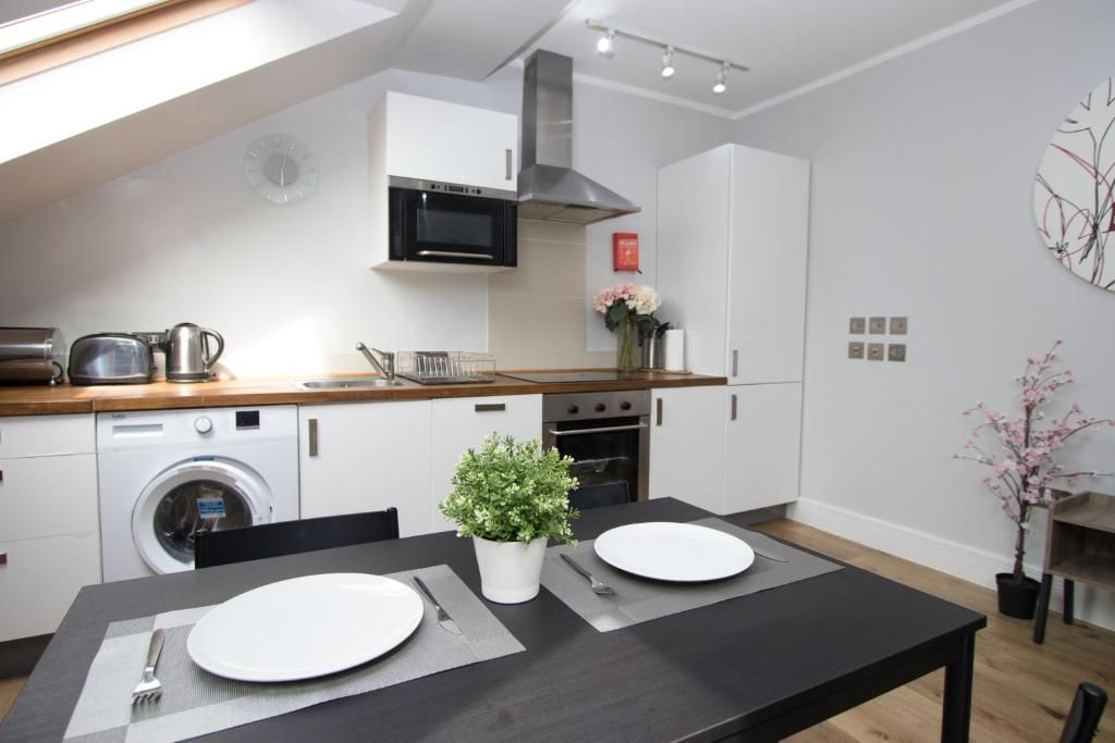 A kitchen with a table and plates on it