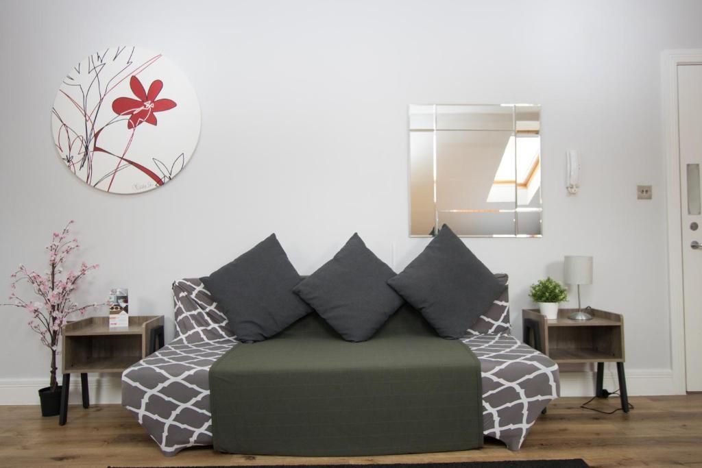 A living room with a couch and a mirror