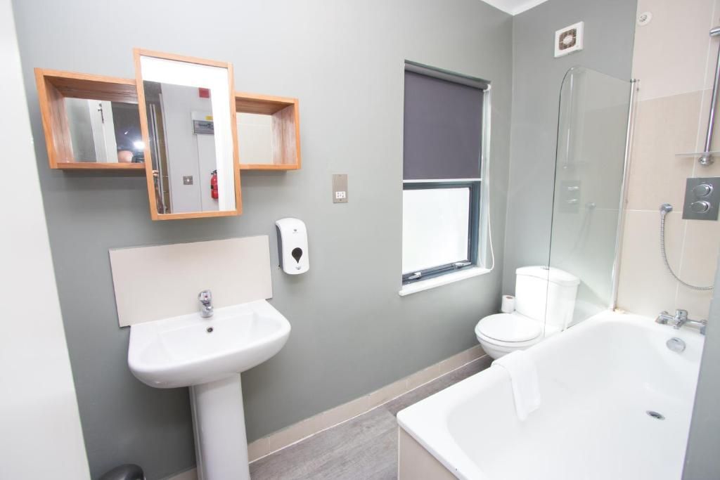 A bathroom with a sink a toilet and a bathtub