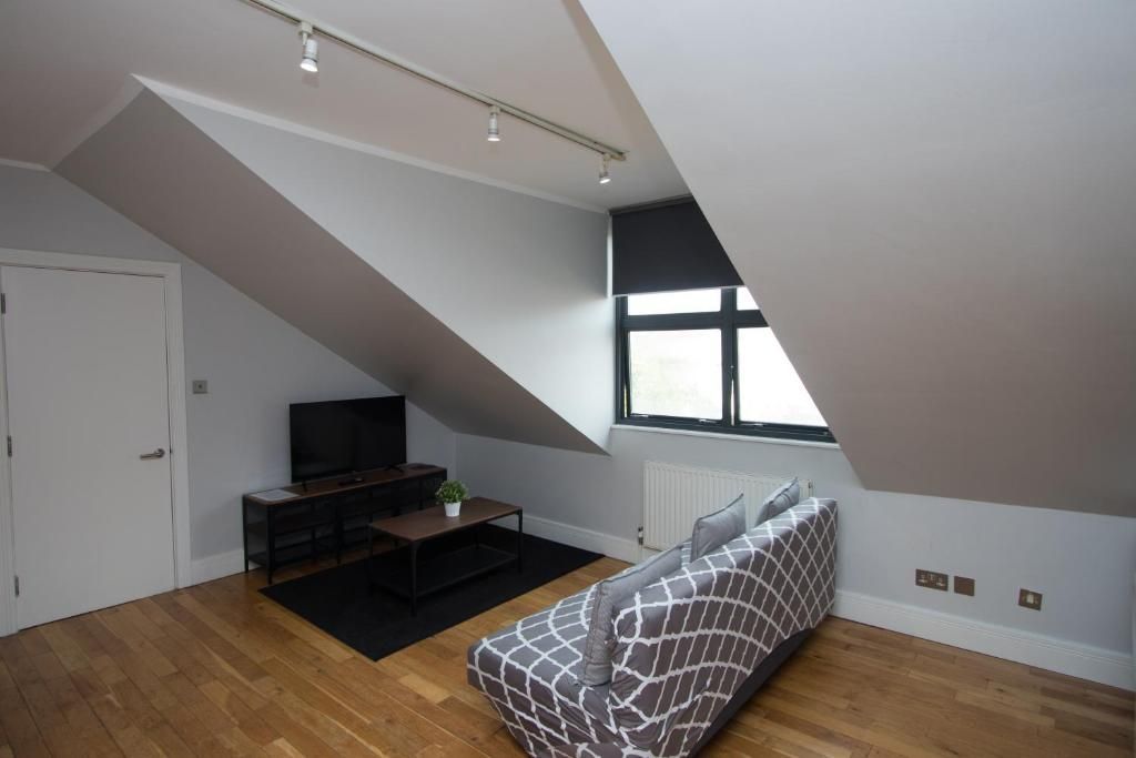 A living room with a couch and a flat screen tv