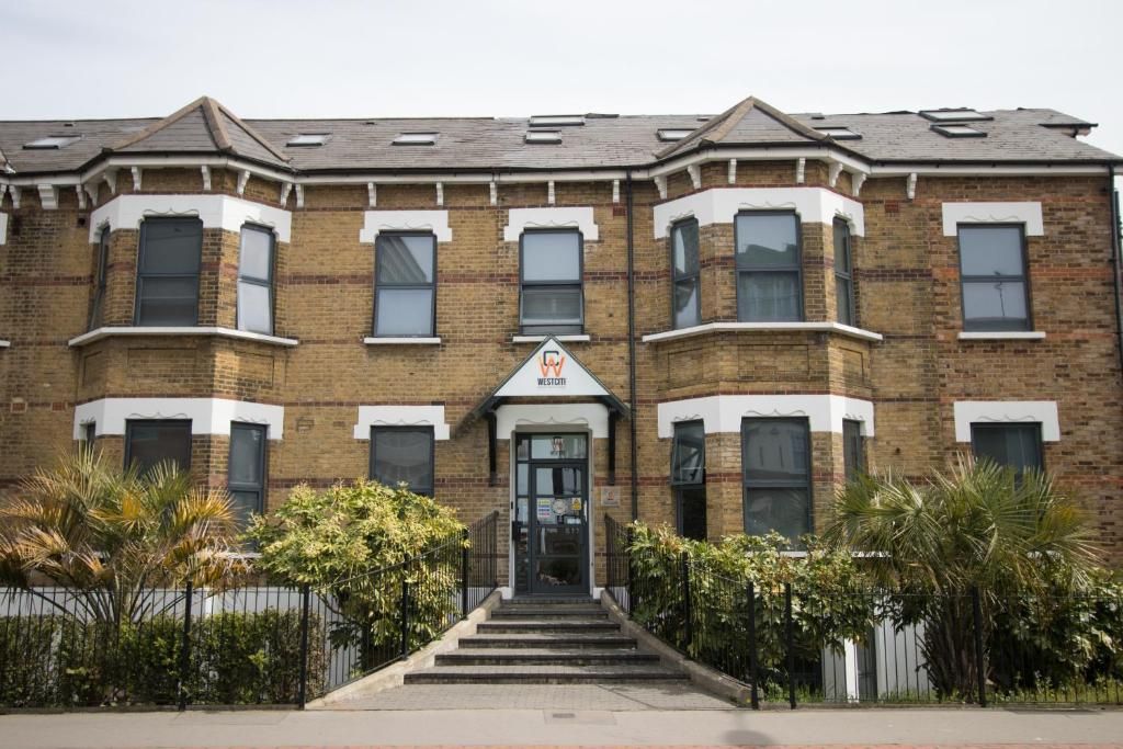 A large brick building with stairs leading up to it