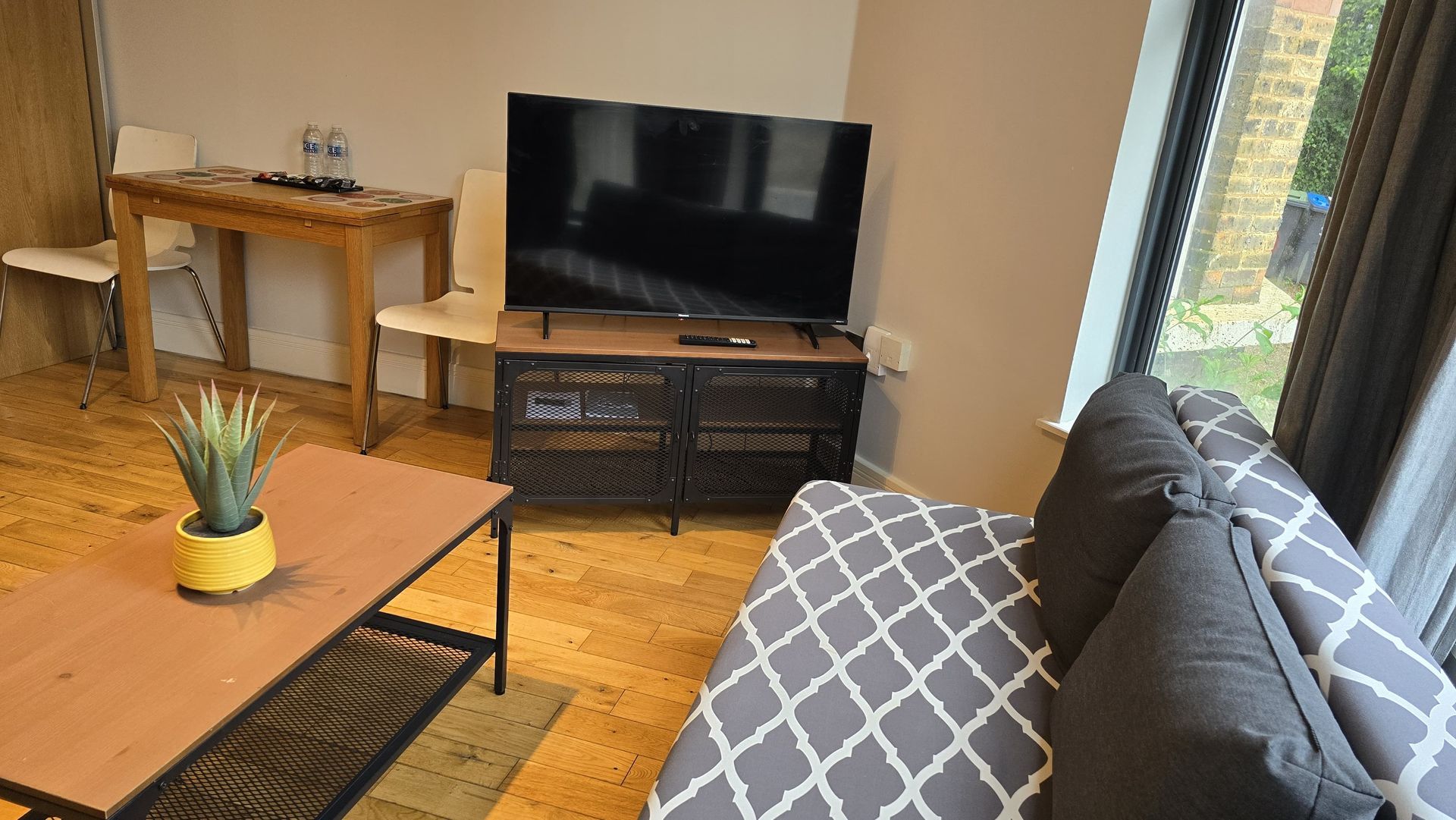 A living room with a couch , table , and television.