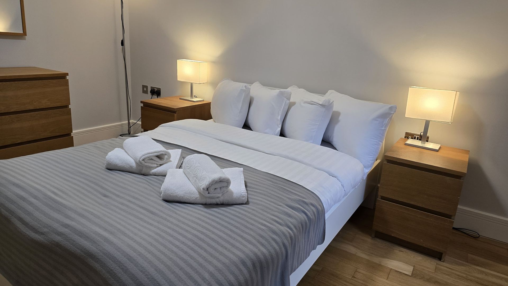 A bedroom with a king size bed and two nightstands