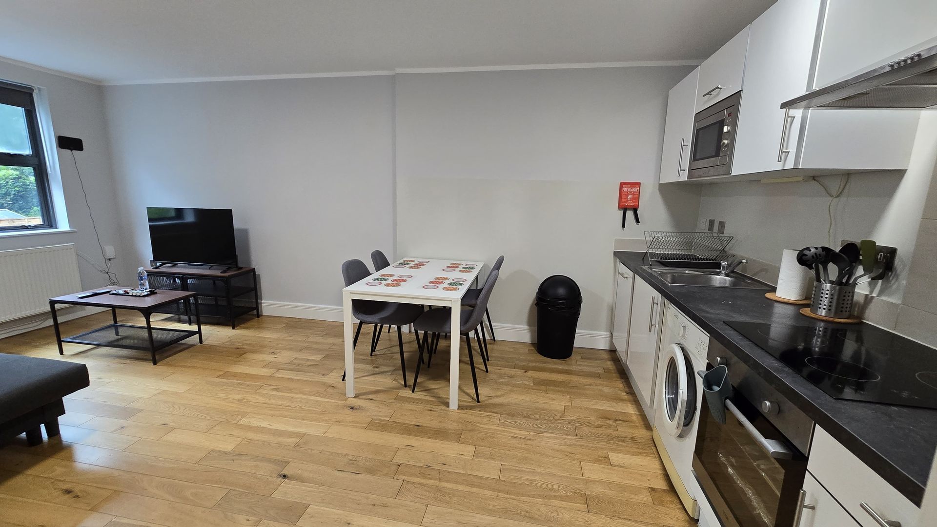 A kitchen with a table and chairs in it.