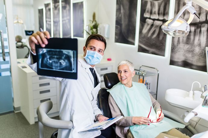 Dentist Checking X-ray Image of Senior Woman — Augusta, GA — J. Martin Echols DMD