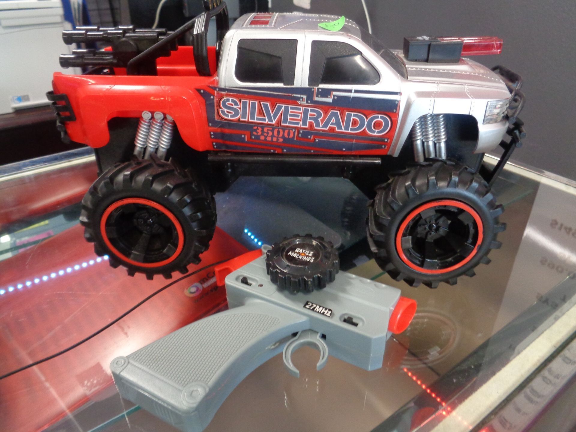Remote control Silverado truck toy with remote. Red, silver and black.