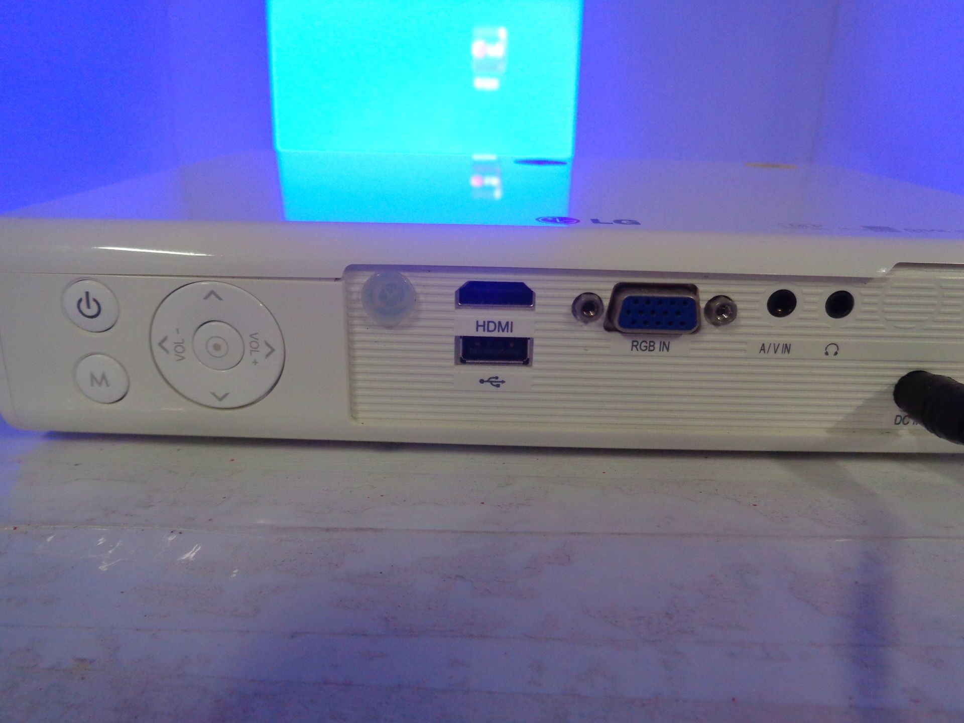 White projector with control buttons and ports, including HDMI, USB, and VGA.
