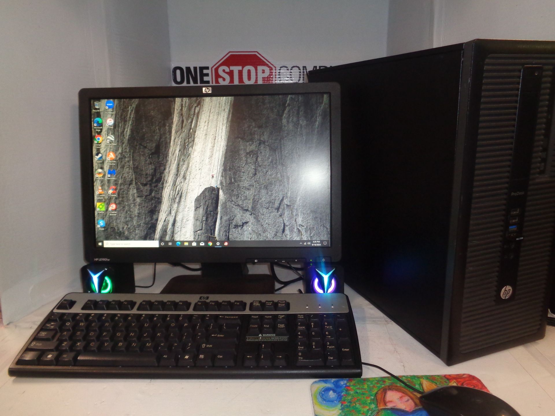 Desktop computer setup with monitor, keyboard, and tower on a white surface.