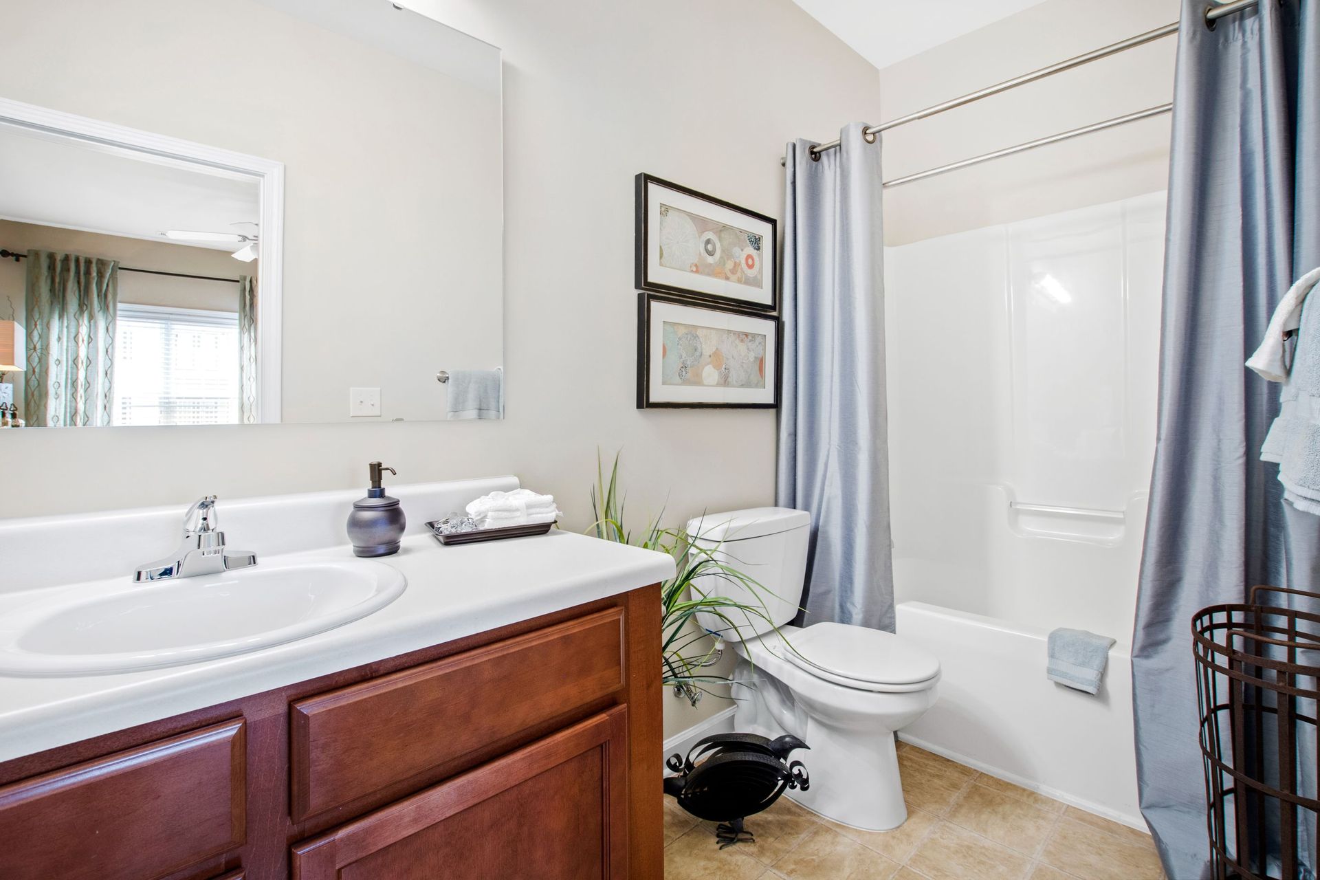 Bathroom in an apartment unit with a single vanity, sink, toilet, and tub/shower.