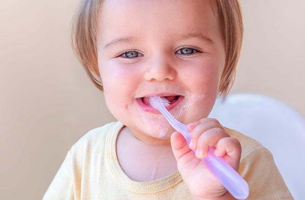toddler girl brushing teeth