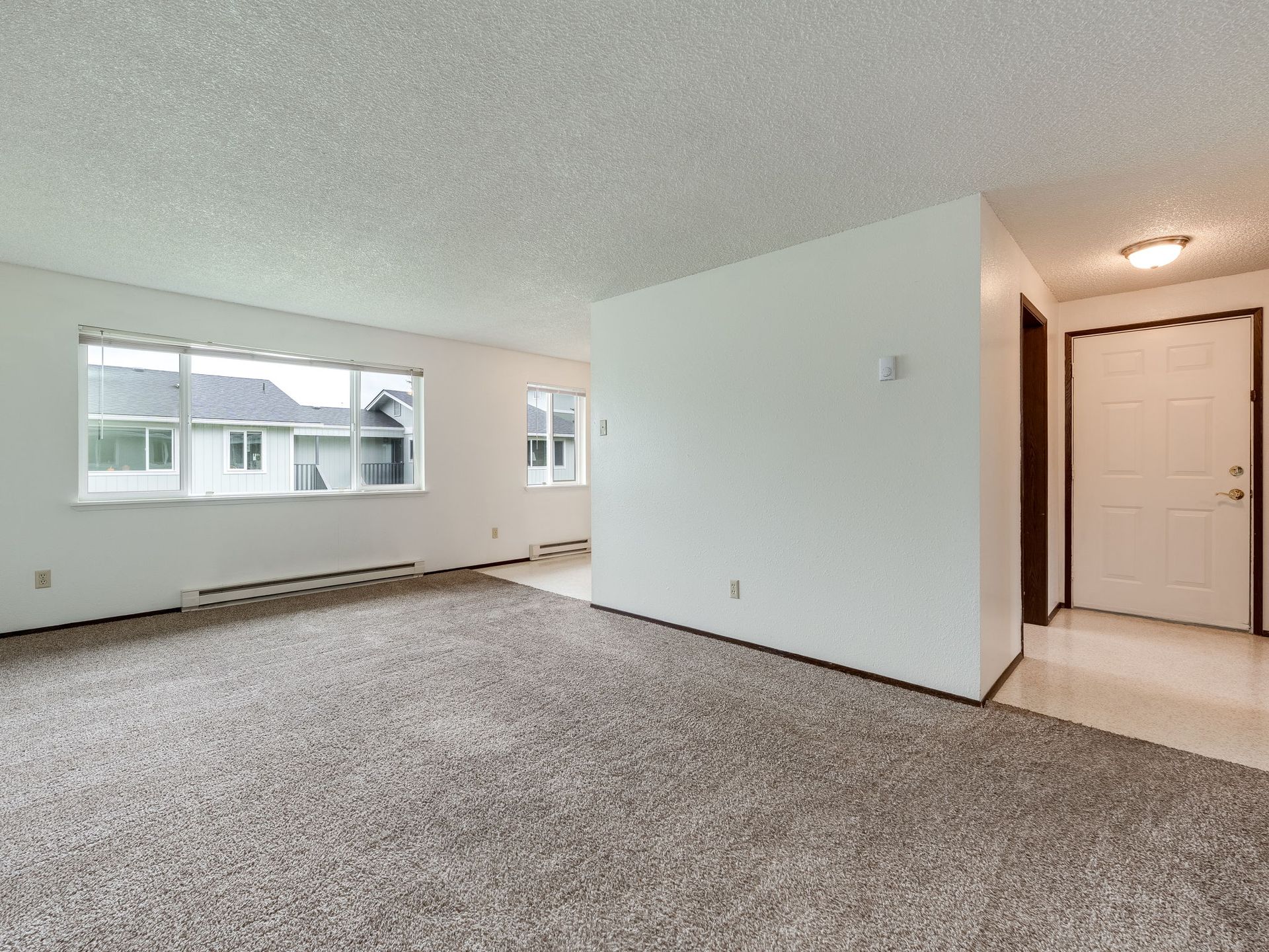 Southridge Apartments 2Bed/1Bath spacious living room with view of large window.