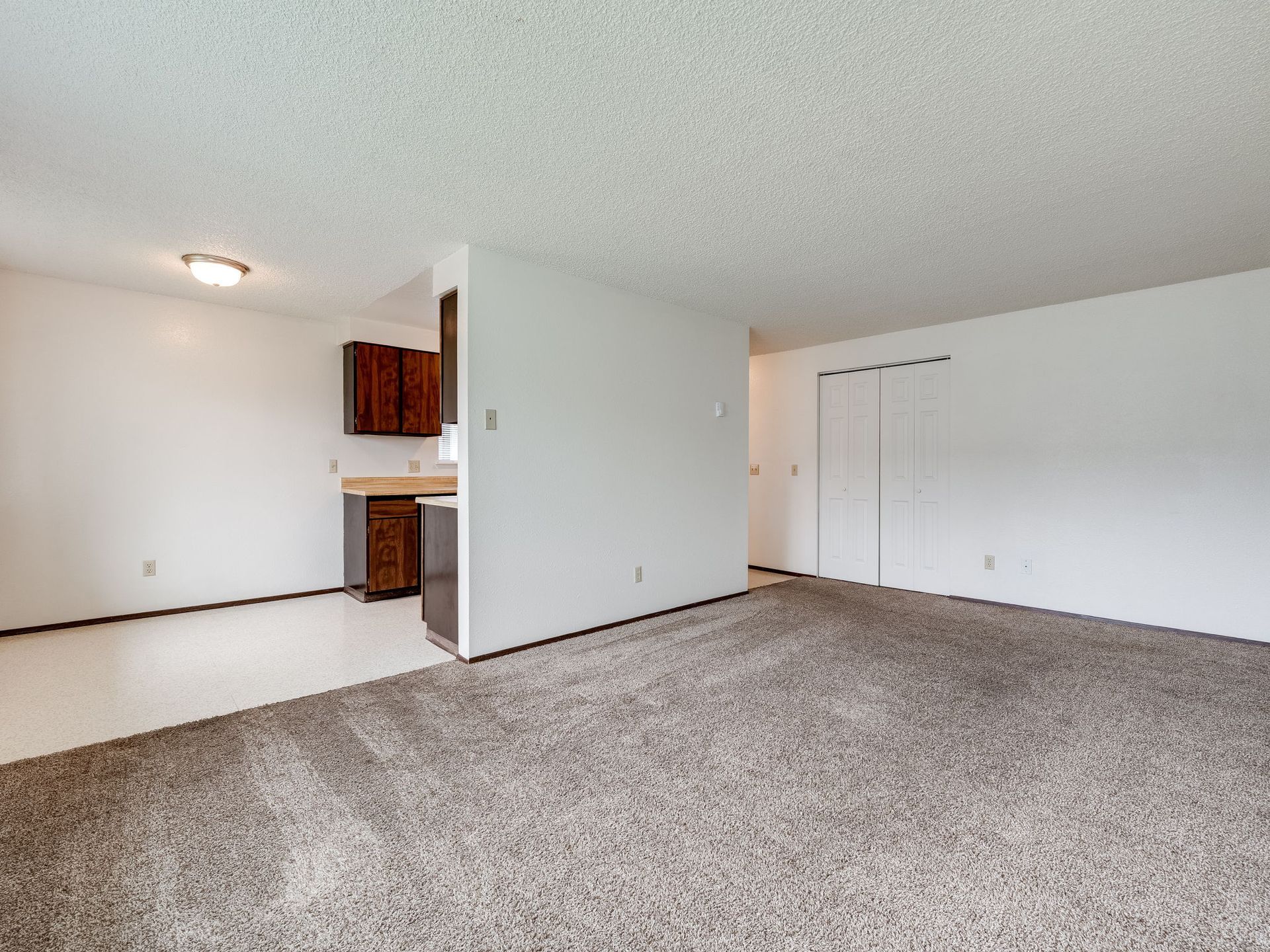 Southridge Apartments 2Bed/1Bath spacious living room with view of dining room.