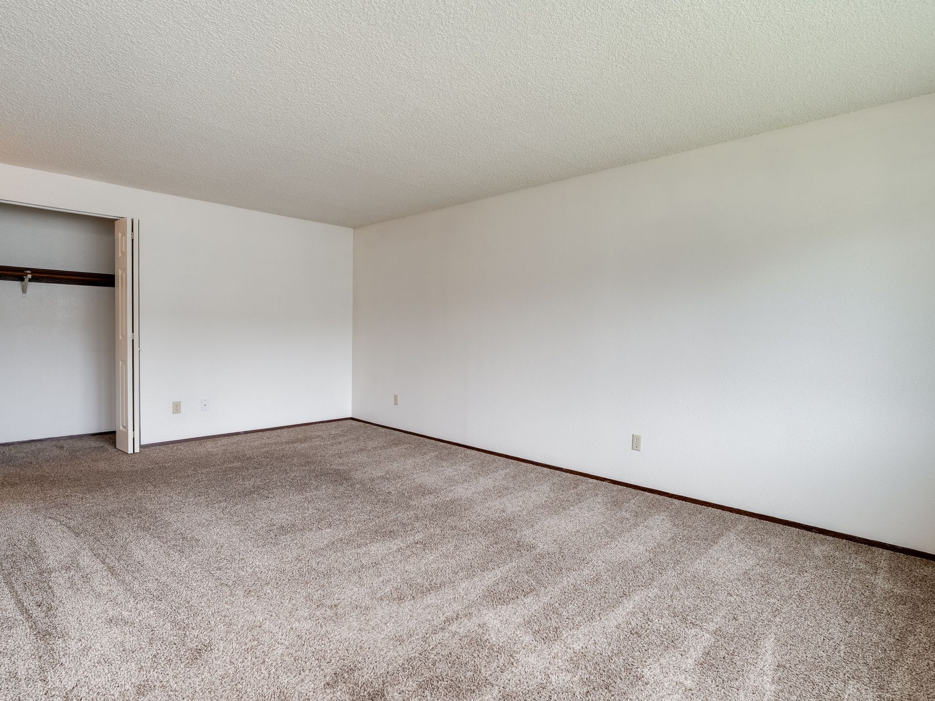 Southridge Apartments 2Bed/1Bath spacious living room with view of storage closet opened.