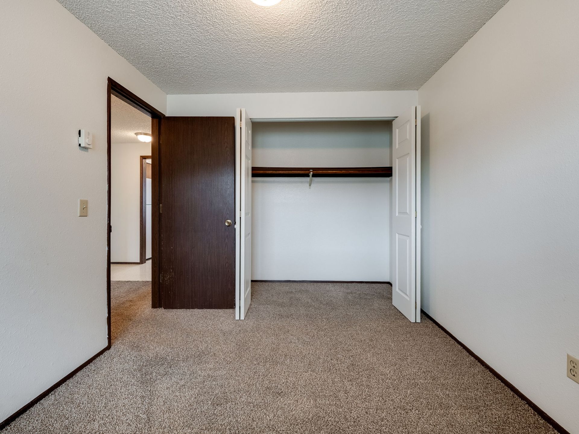 Southridge Apartments 2Bed/1Bath bedroom 1 with view of door and opened closet.