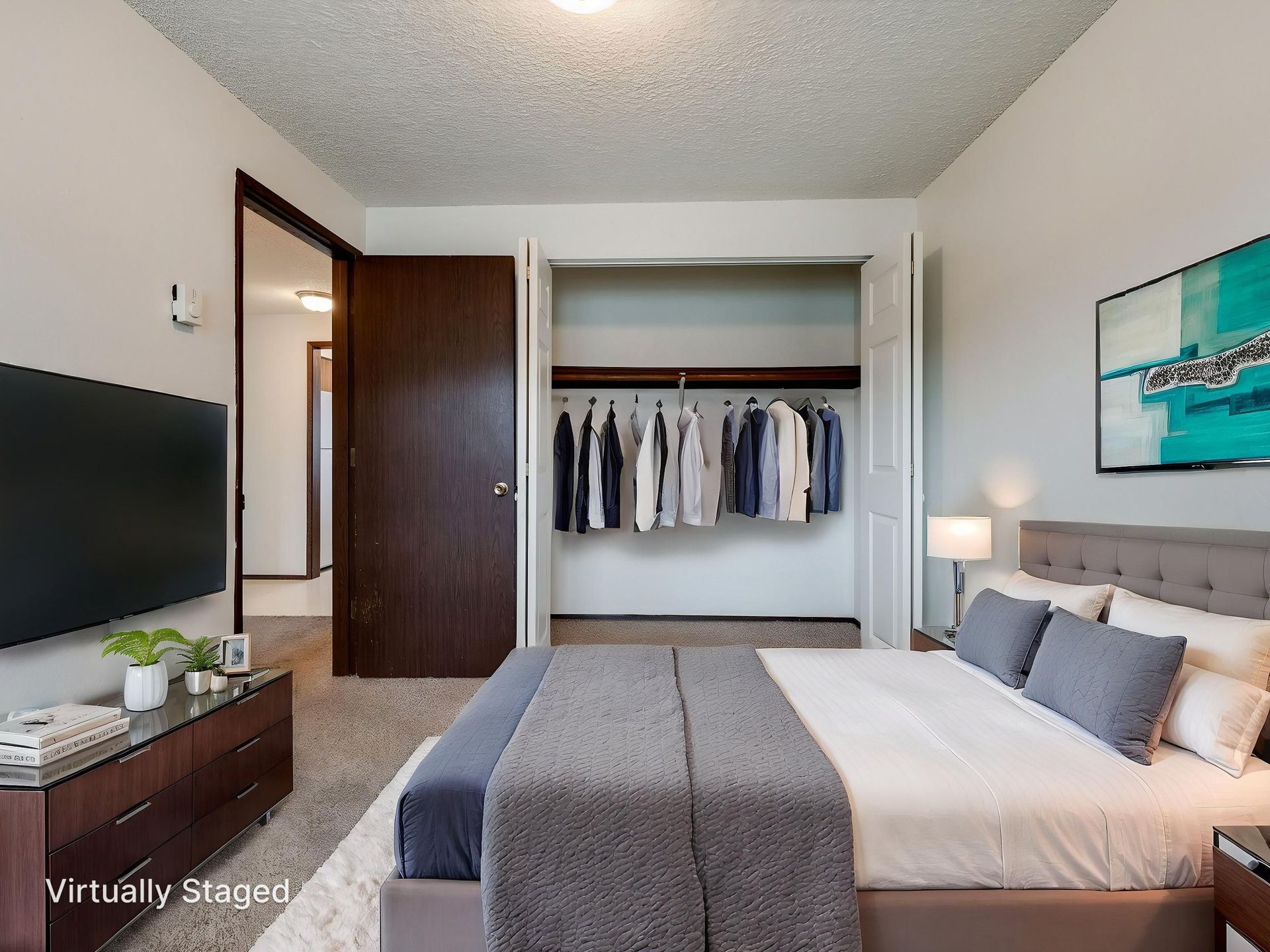 Southridge Apartments 2Bed/1Bath bedroom 1 with view of door and opened closet virtually staged.