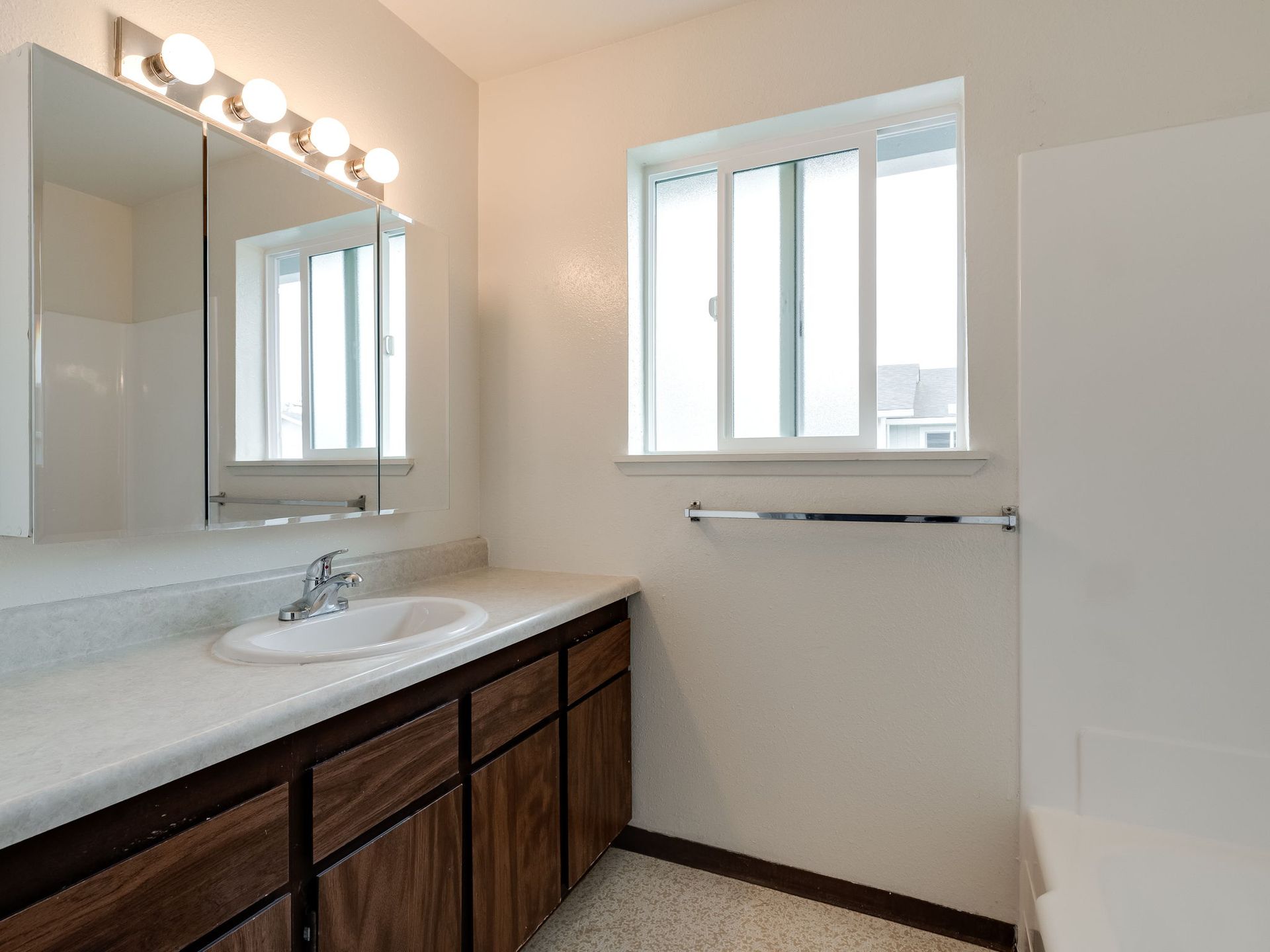 Southridge Apartments 2Bed/1Bath bathroom with view of vanity and window.