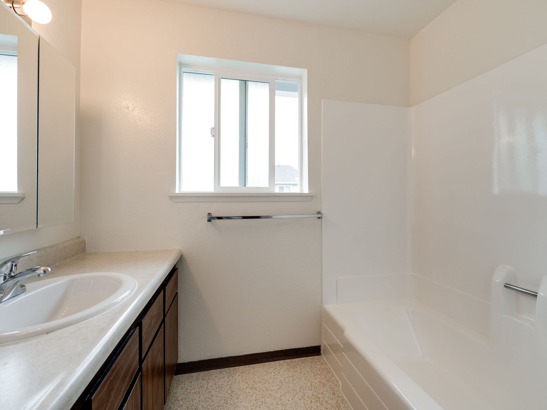 Southridge Apartments 2Bed/1Bath bathroom with view of window and tub.