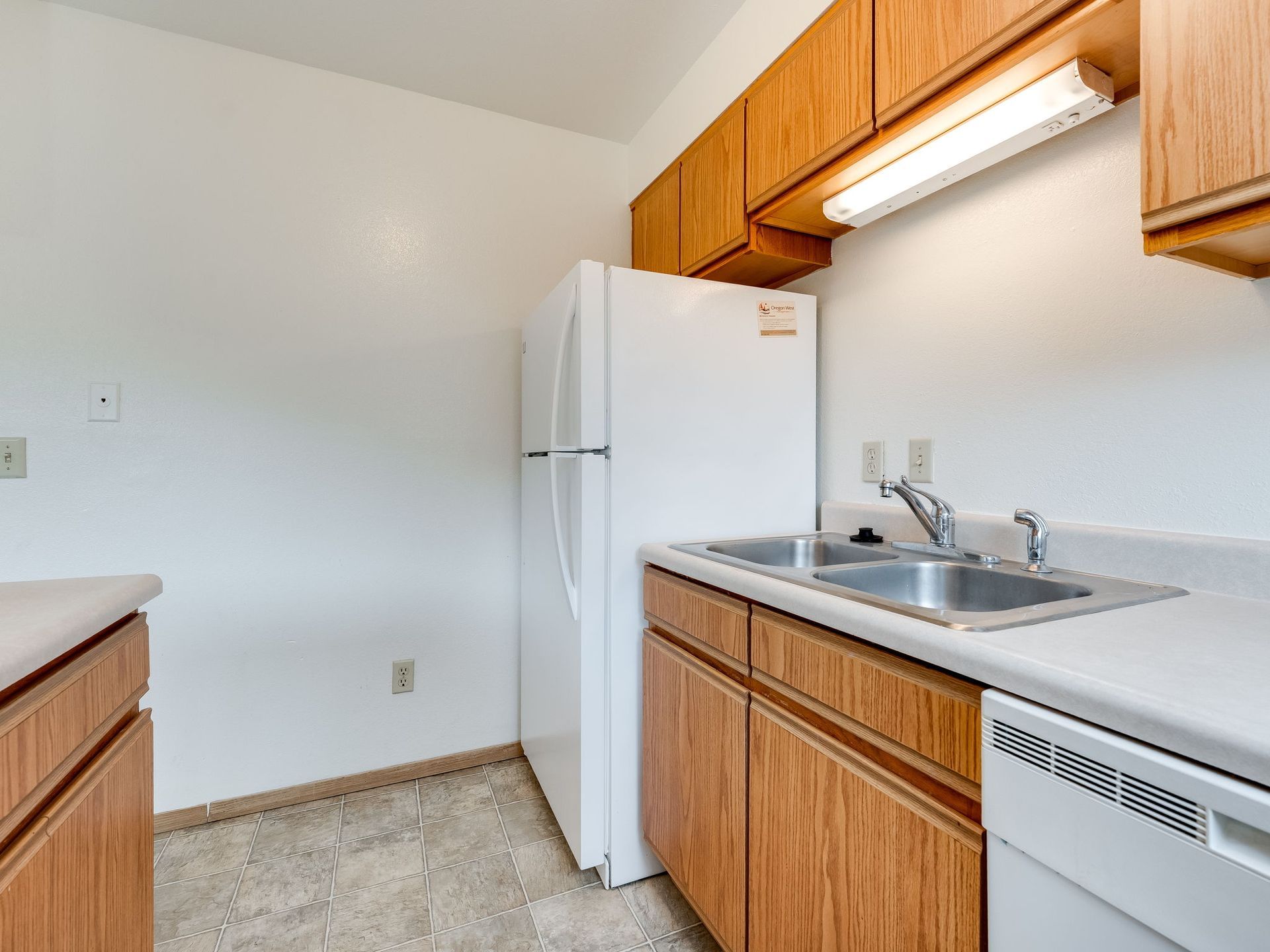 Southridge Apartments Townhome kitchen with view of refrigerator and sink.