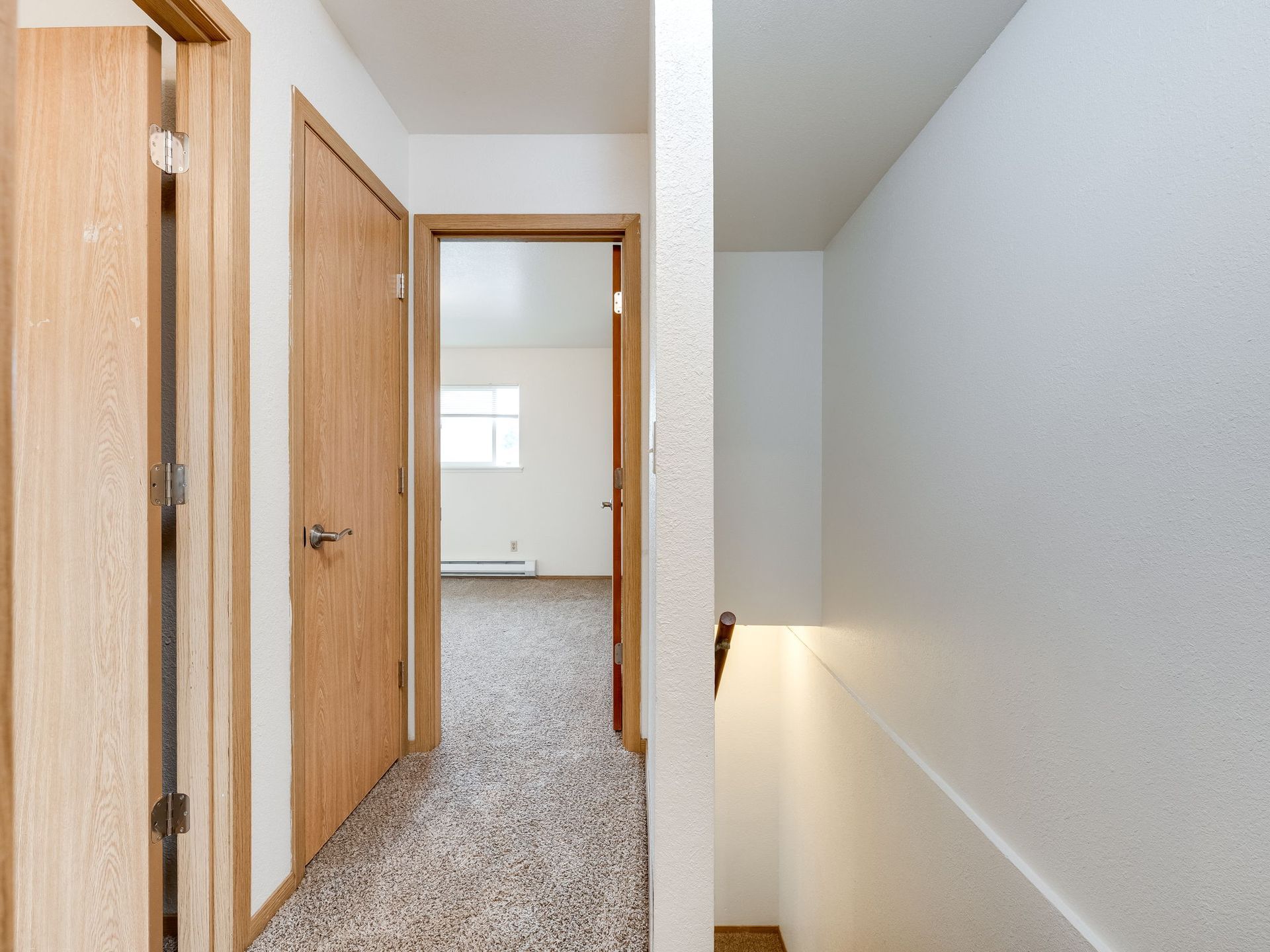 Southridge Apartments Townhome upstairs hallway looking into bedroom 1.